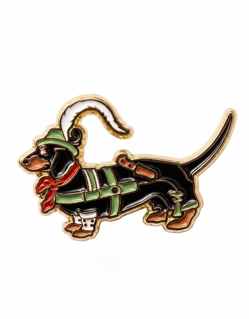 Bunter Emaille-Pin "Dackel in Lederhose" mit grünem Trachtenhut, rotem Halstuch und weißer Feder.