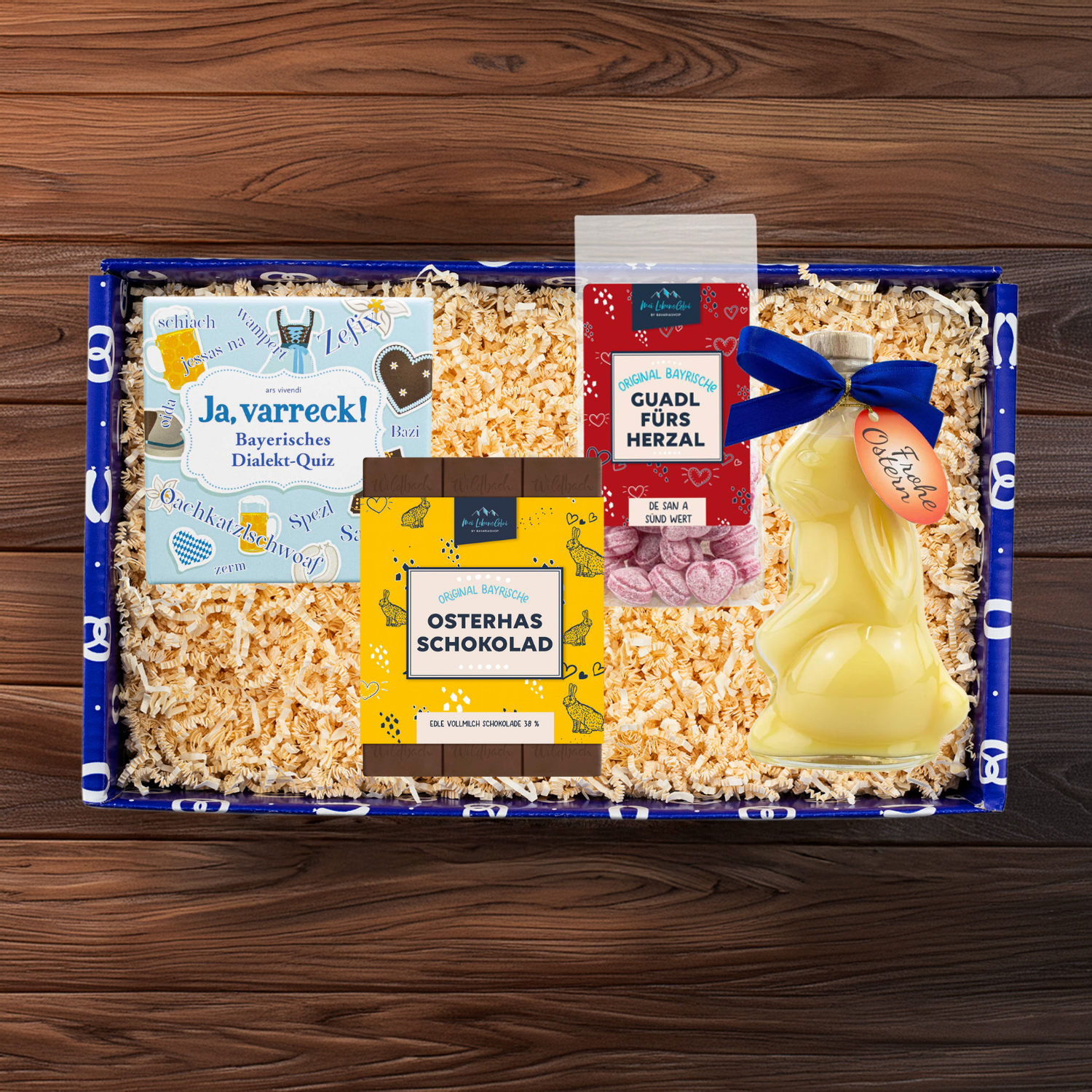 Geschenkbox mit Hasen-Eierlikörflasche, Schokoladenosterhasen, Kartenspiel „Ja, varreck!“ in Naturkarton.