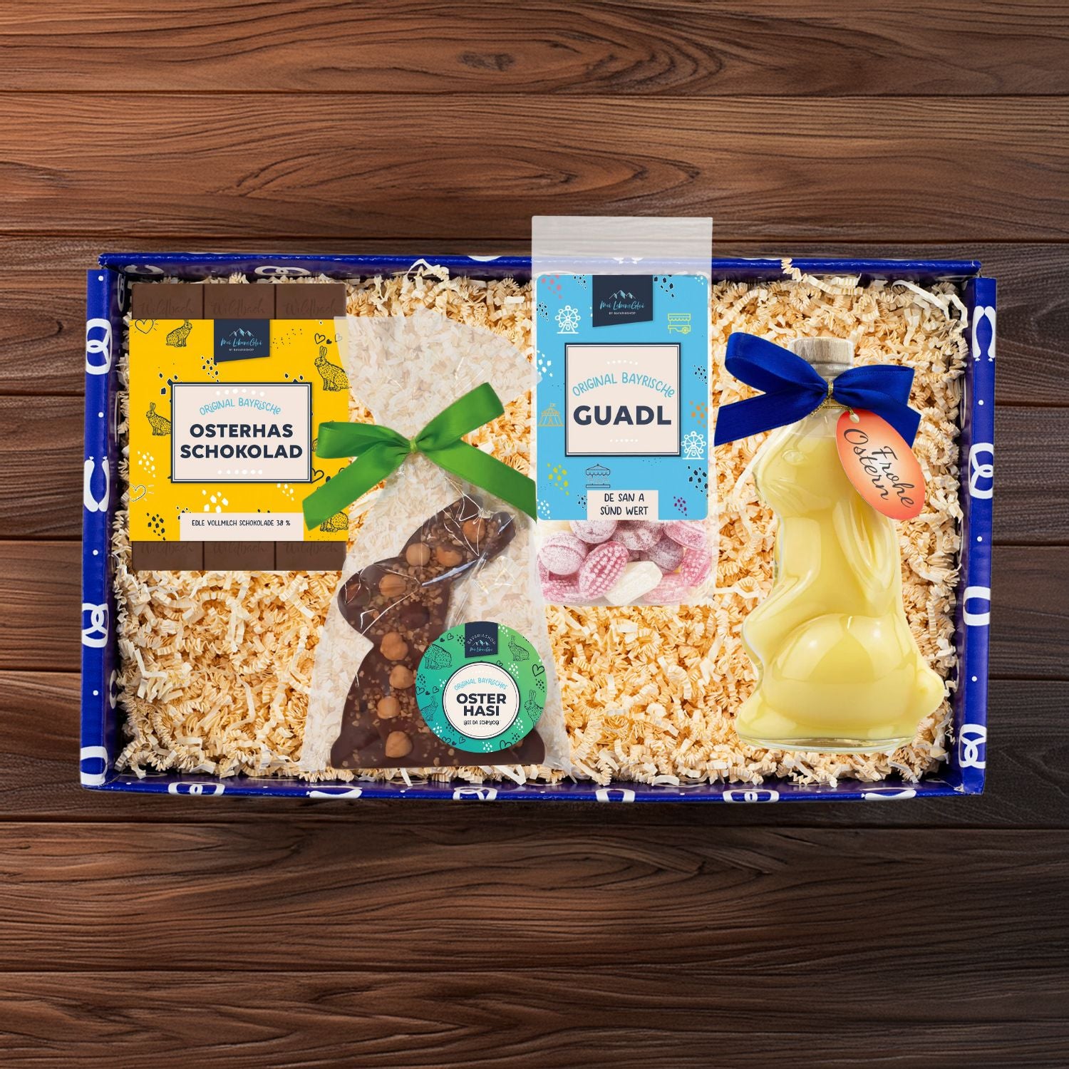 Geschenkbox "Gruaß vom Osterhas" mit Hasenlikör, Osterschokolade, Schokohase und Oster-Guadl.