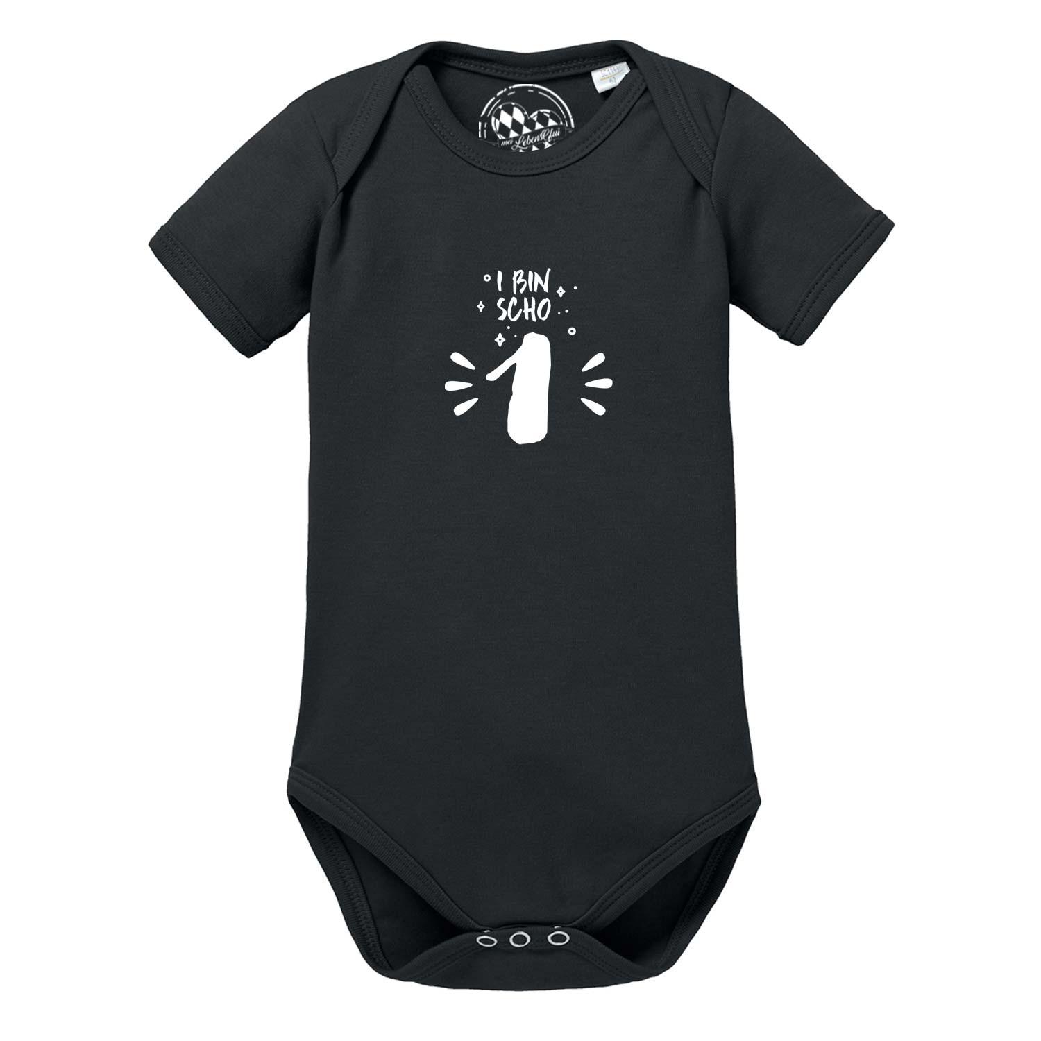 Schwarzer Baby Body I bin scho 1 mit weißem, bayerischem Aufdruck zum ersten Geburtstag, kurzärmlig.