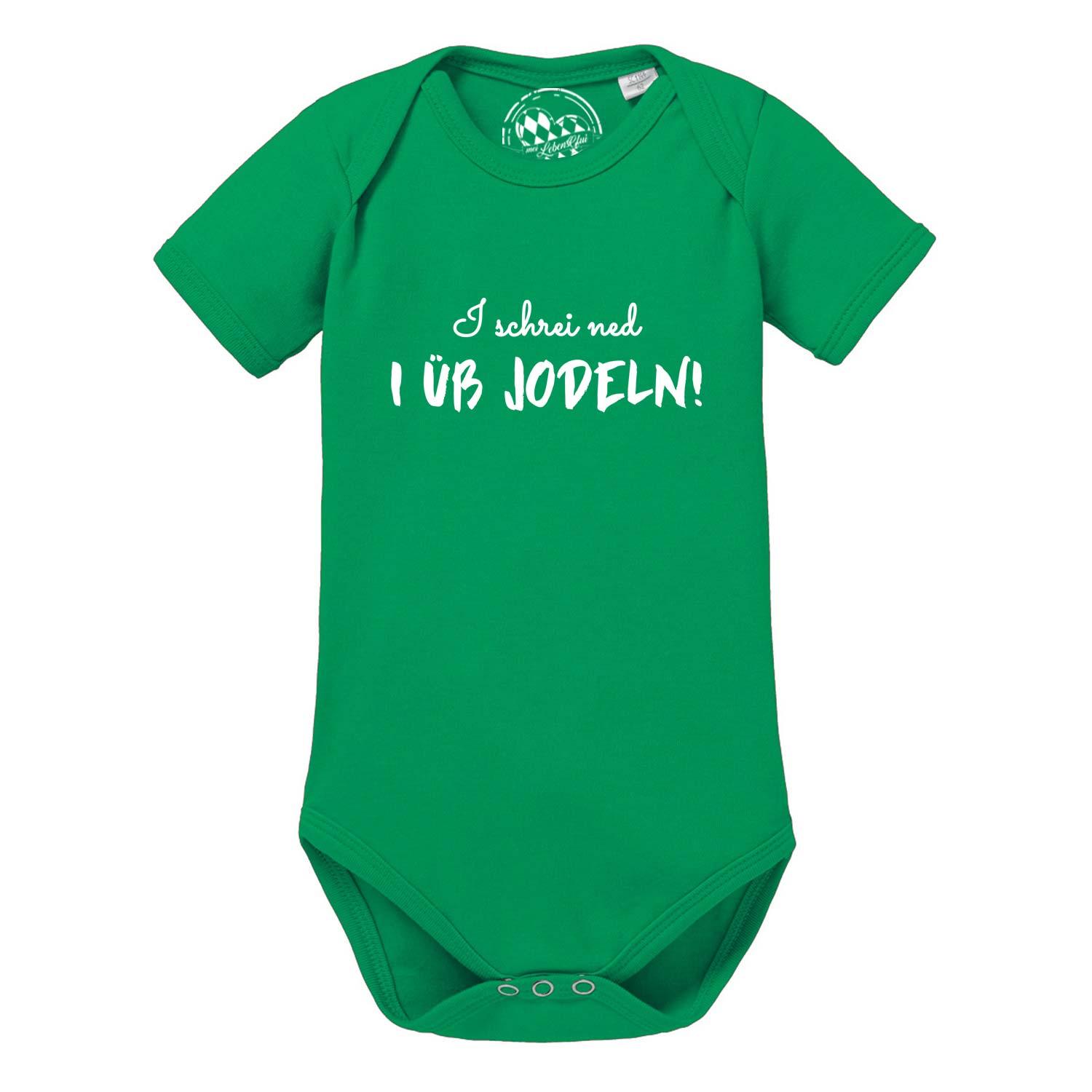 Kurzärmeliger Babybody in Weiß mit schwarzem Schriftzug „I üb jodeln“ und Jodelmotiv auf weicher Baumwolle.
