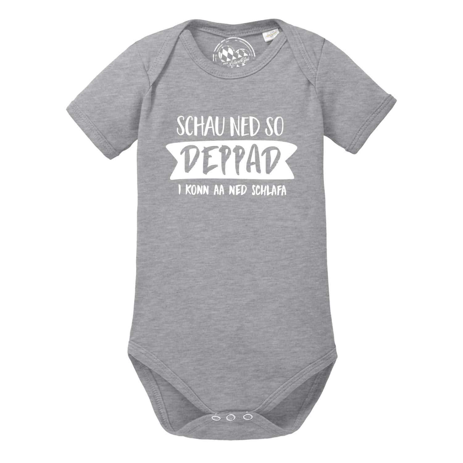 Kurzärmeliger weißer Baby-Body mit dunkelblauem Aufdruck „schau ned so…“, runder Halsausschnitt, aus Baumwolle.