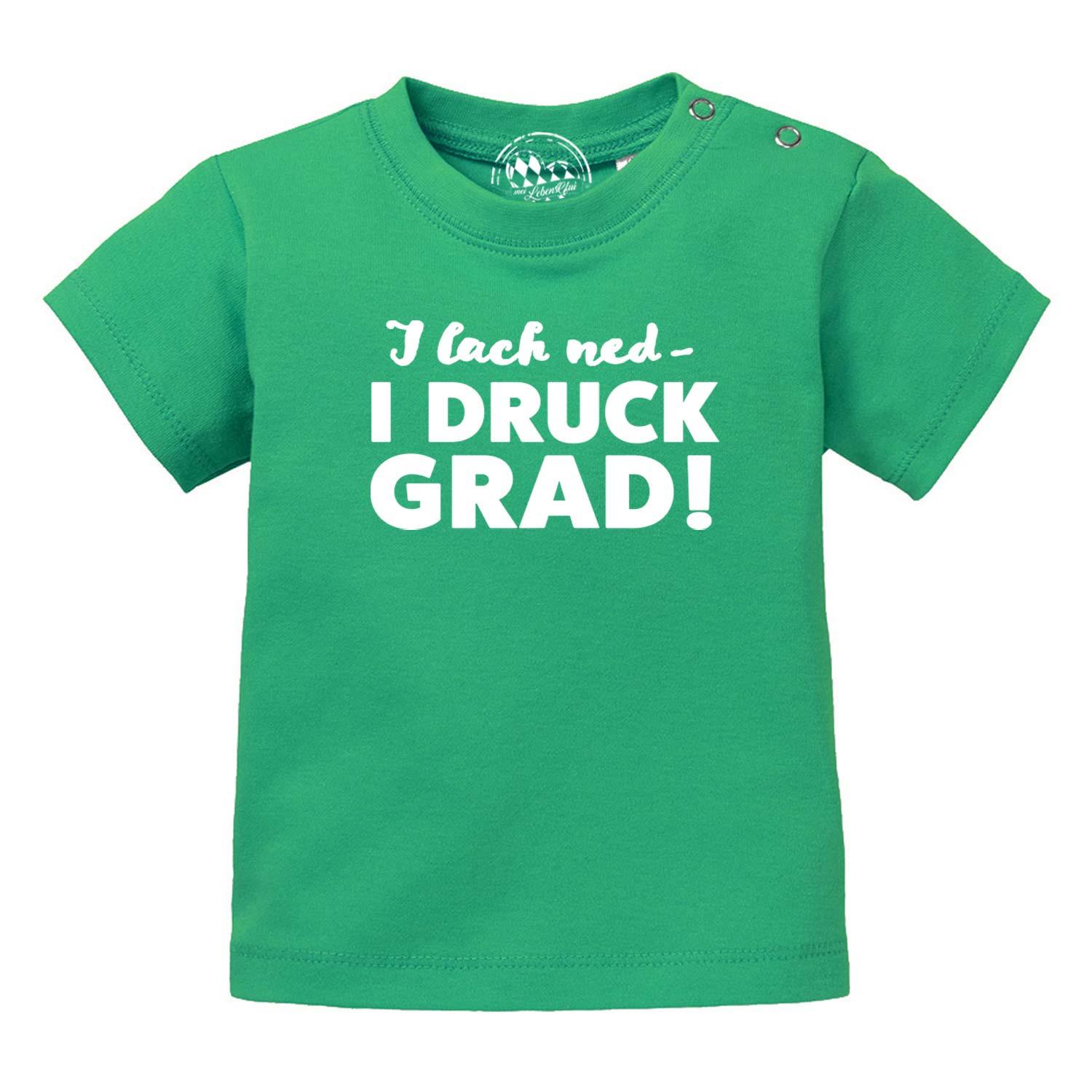 Bayerisches Baby-T-Shirt in Weiß mit schwarzem Schriftzug „I lach ned...“, Kurzarm, aus 100 % Bio-Baumwolle.