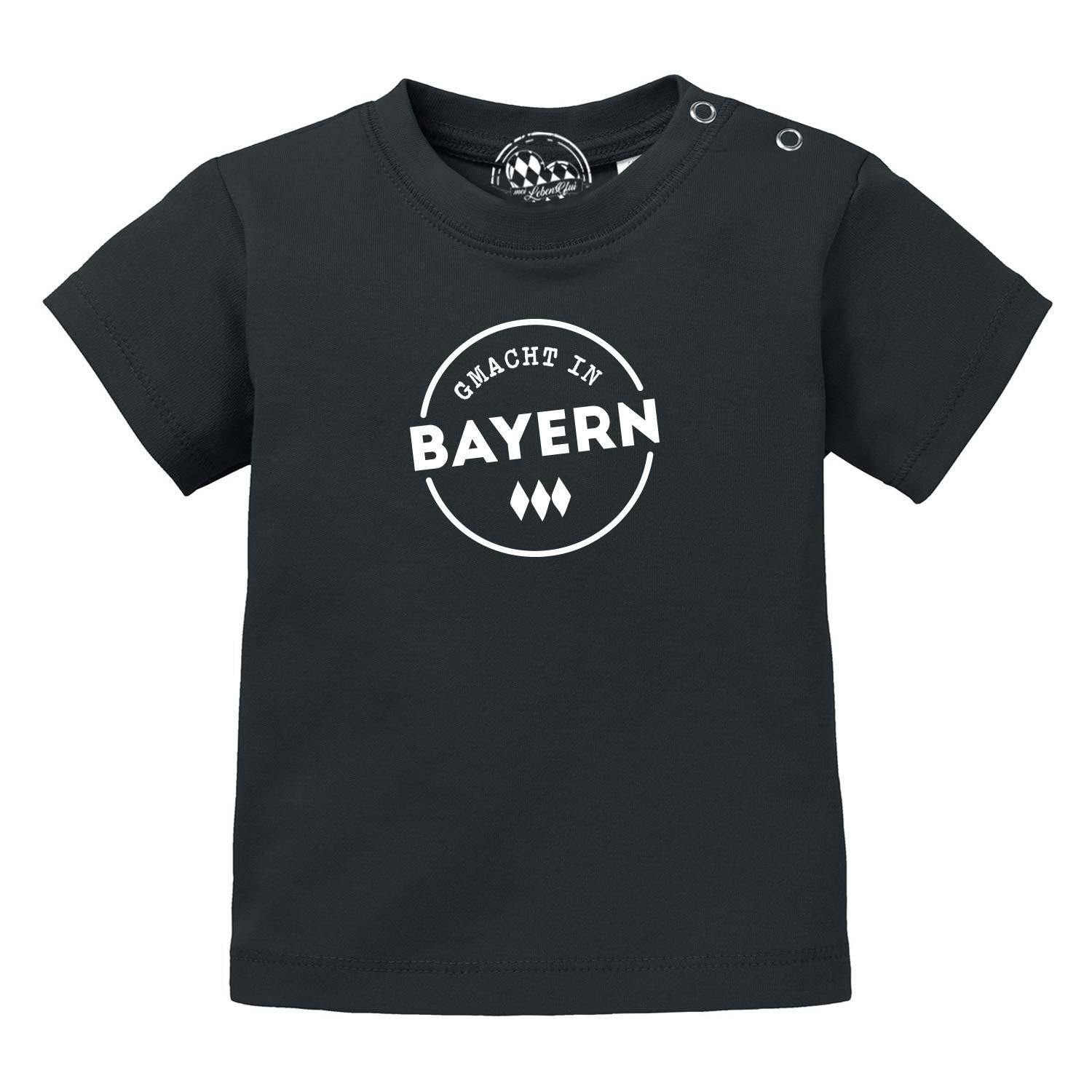 Schwarzes Baby T-Shirt "Gmacht in Bayern" mit weißem bayerischen Aufdruck und Rautenmuster.