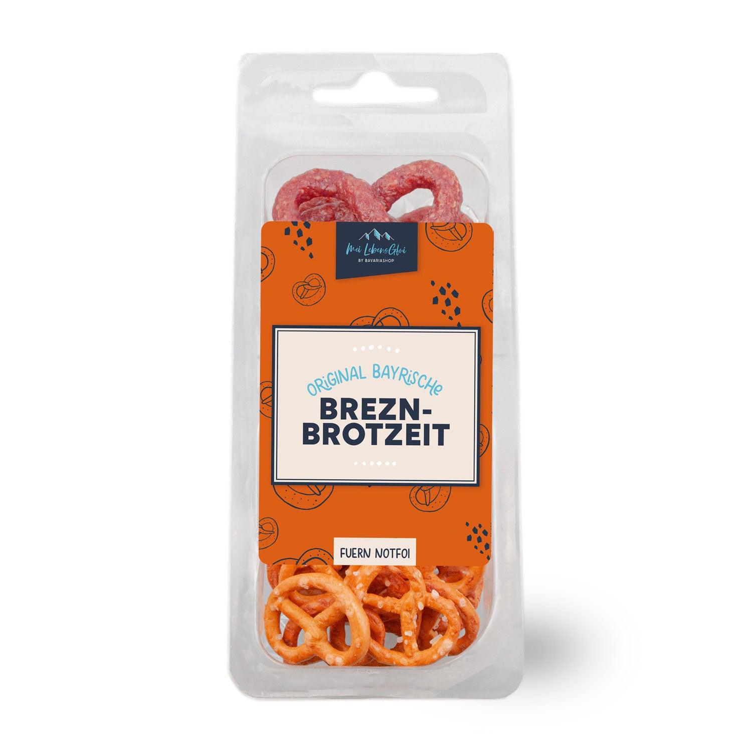 Brezn-Brotzeit mit goldbrauner Salzbreze, herzförmigem Lebkuchen mit Wunschtext und Marzipan-Weißwurstpaar.