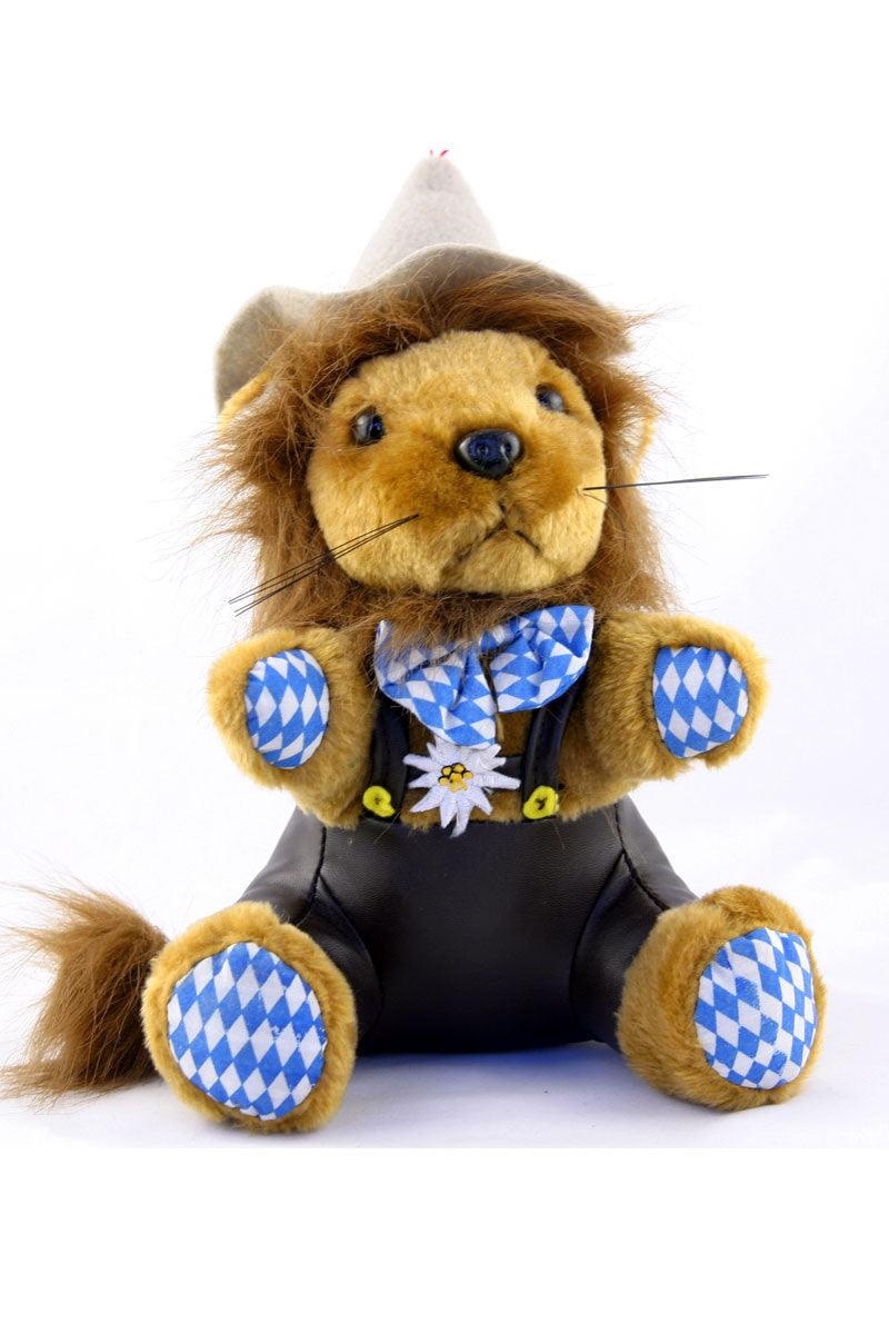 Plüschlöwe im bayerischen Design mit brauner Lederhose, grünem Filzhut und gesticktem Edelweiß-Motiv.