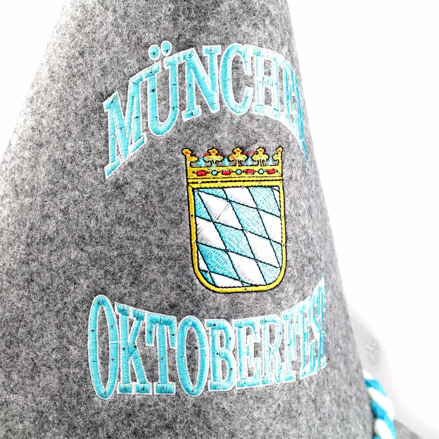 Grauer Trachtenhut mit blauer LED-Stickerei „München Oktoberfest“, weiß-blauer Kordel und Bayernwappen.