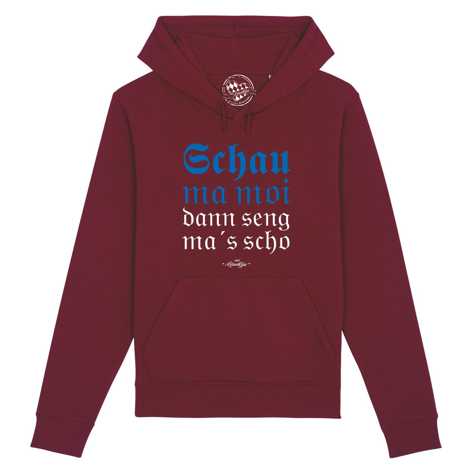 Damen Hoodie in Rosa mit weißem „Schau ma moi“-Schriftzug, Kapuze, Kängurutasche und Raglanärmeln aus Bio-Baumwollmix.