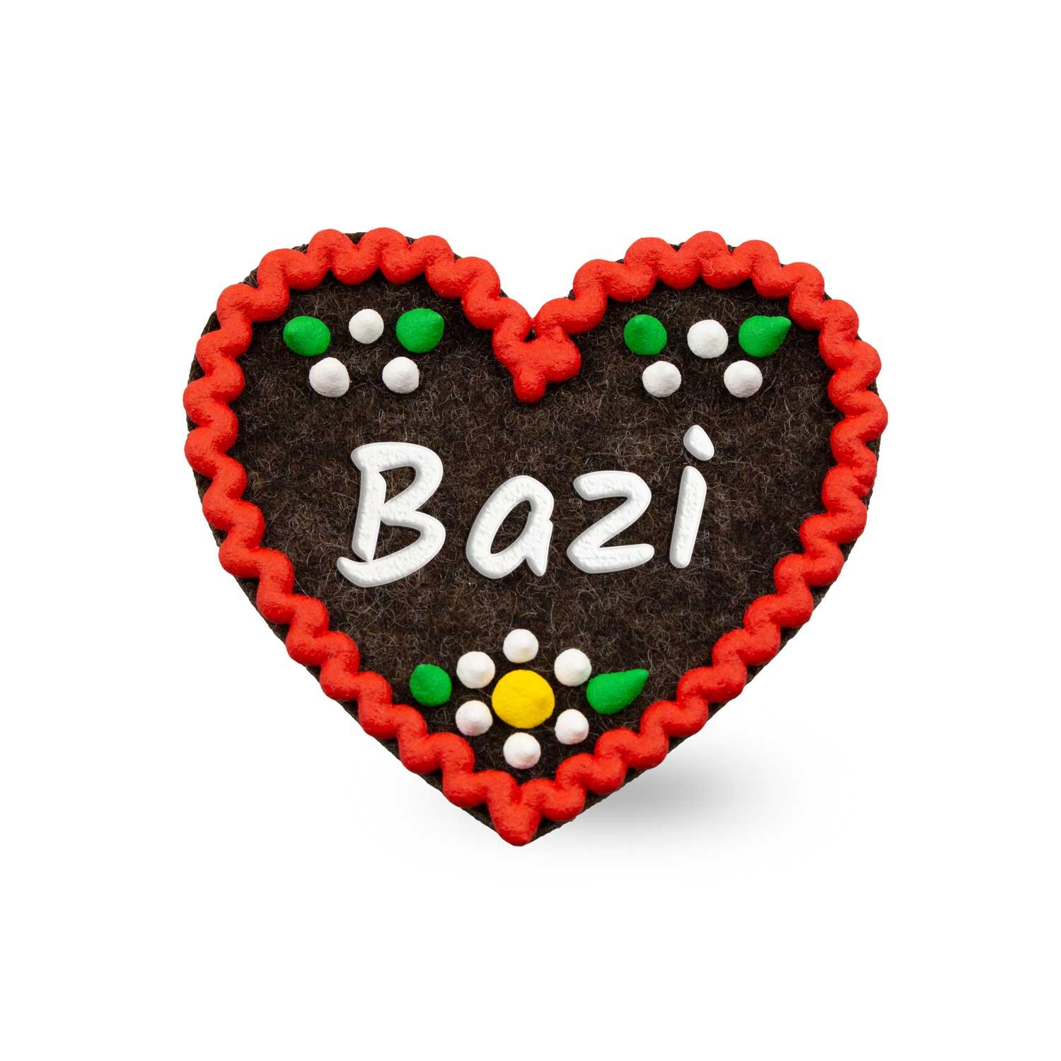 Herzförmiger Filz-Anstecker mit gesticktem Schriftzug „Bazi“, sichtbarer Struktur und Sicherheitsnadel auf Rückseite.