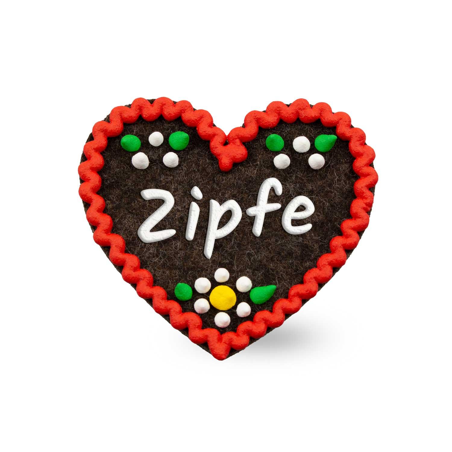 Herzförmiger Filz-Anstecker mit gesticktem Schriftzug „Zipfe“, Sicherheitsverschluss auf der Rückseite, ca. 6,5 × 7 cm.