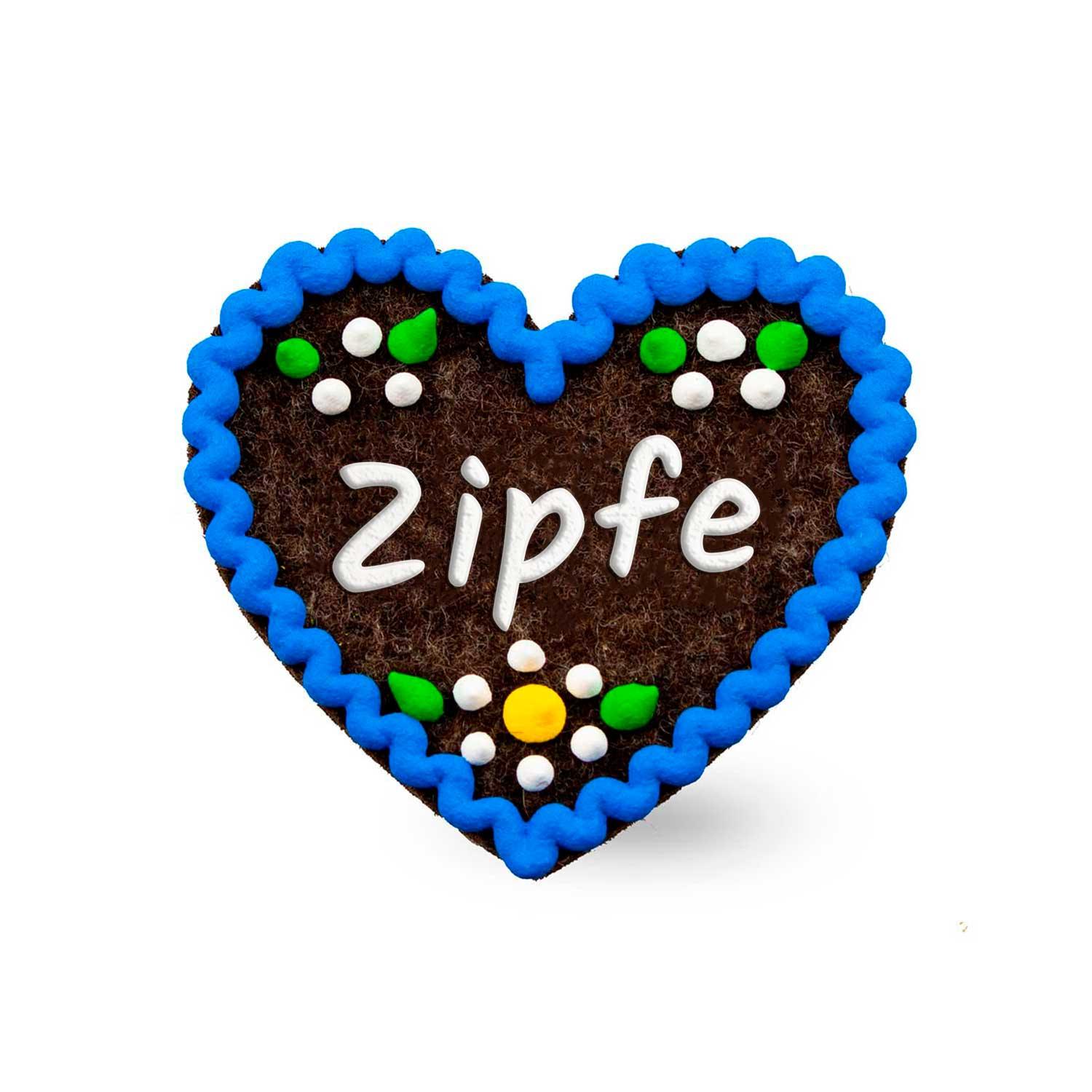 Herzförmiger Filzanstecker mit besticktem Schriftzug „Zipfe“ und Sicherheitsverschluss auf der Rückseite, ca. 6,5 x 7 cm.
