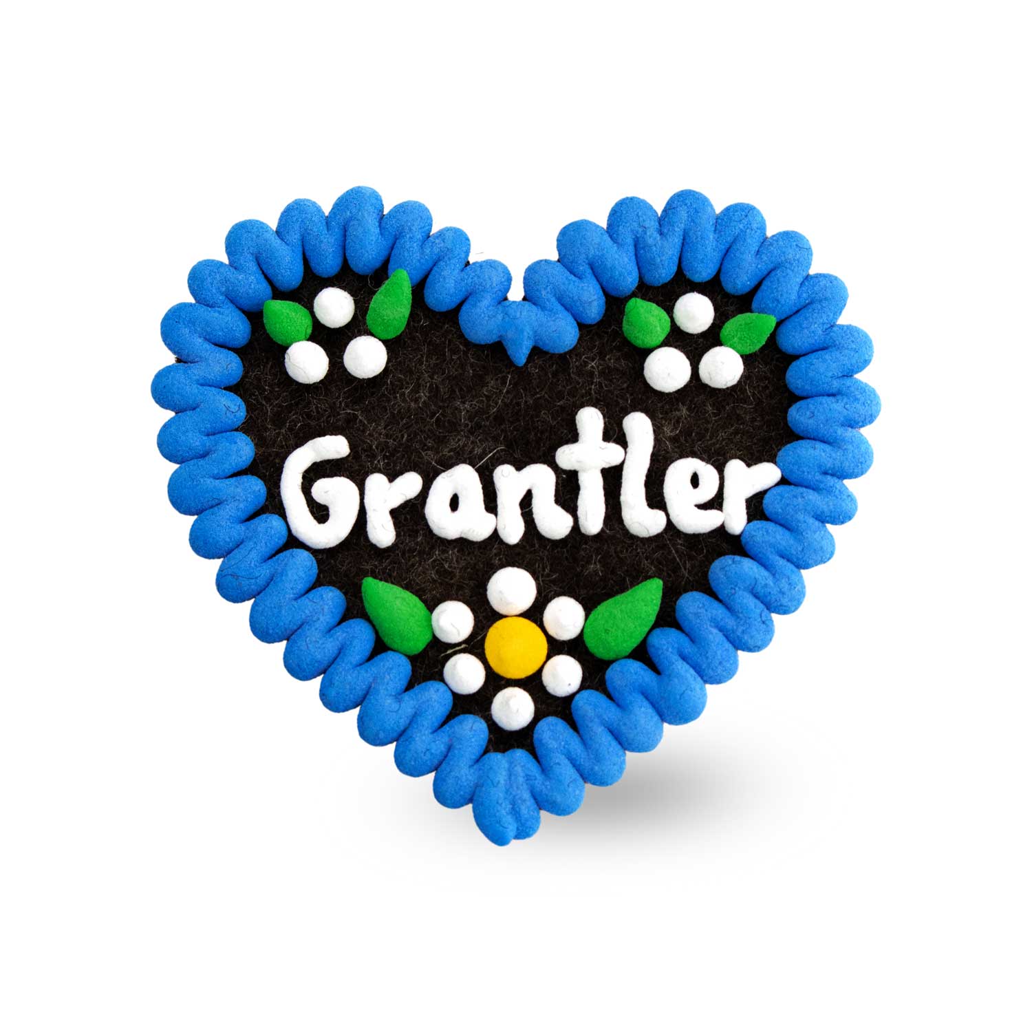 Herzförmiger Filz-Anstecker mit gesticktem Schriftzug „Grantler” und Zierborte, Rückseite mit Sicherheitsnadel, ca. 6,5 x 7 cm.