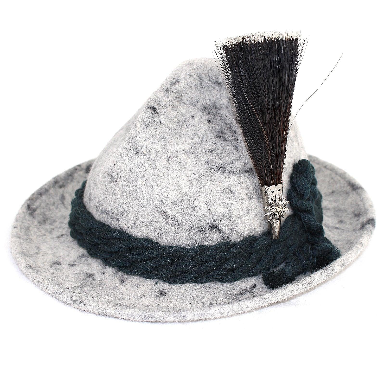 Traditioneller Gamsbart mit Edelweiß-Metallelement, fächerförmig gebunden aus dunklem Antilopenhaar, ca. 13 cm hoch.