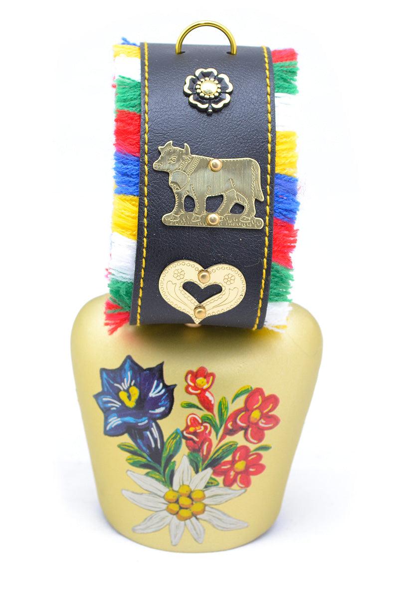 Handbemalte Kuhglocke mit floralem Edelweiß-Motiv, Metallkorpus, Fransenband in Schwarz-Rot-Gold.