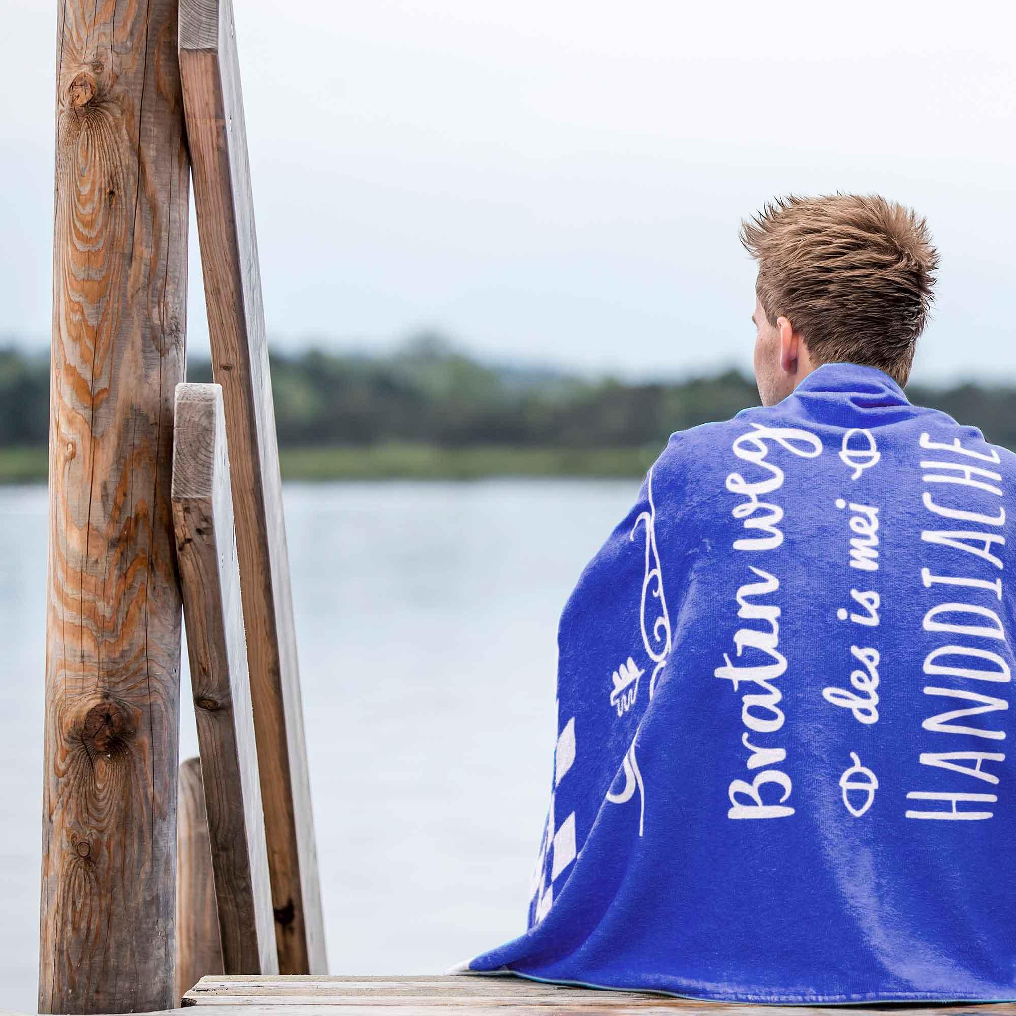 Kuscheliges Badetuch in Dunkelblau mit großem weißem Schriftzug „Bratzn weg“, rechteckig, Baumwolle, 80 x 155 cm.