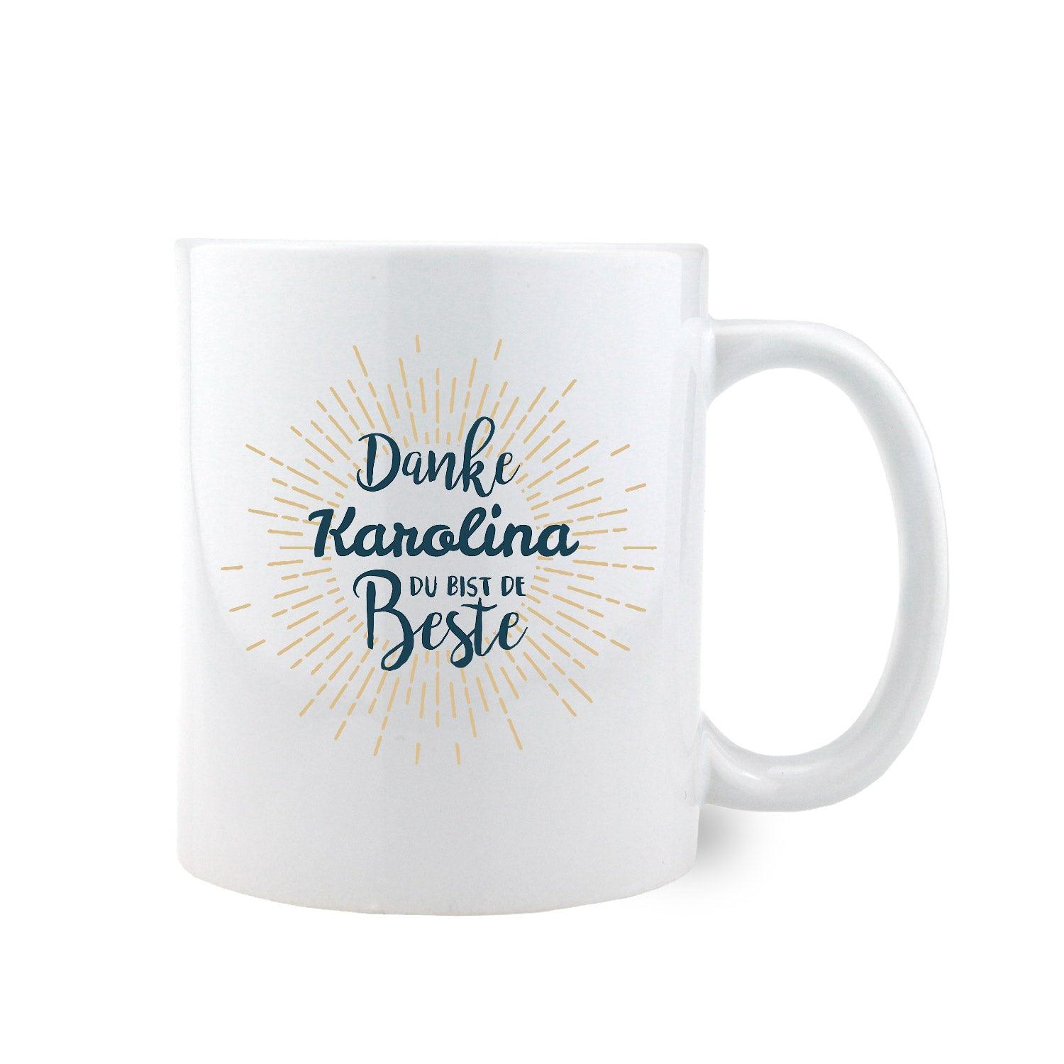 Weiße Keramiktasse mit seitlichem Henkel, schwarzem Rand und Schriftzug „Danke, bist de Beste“ in Schwarz; 330 ml.