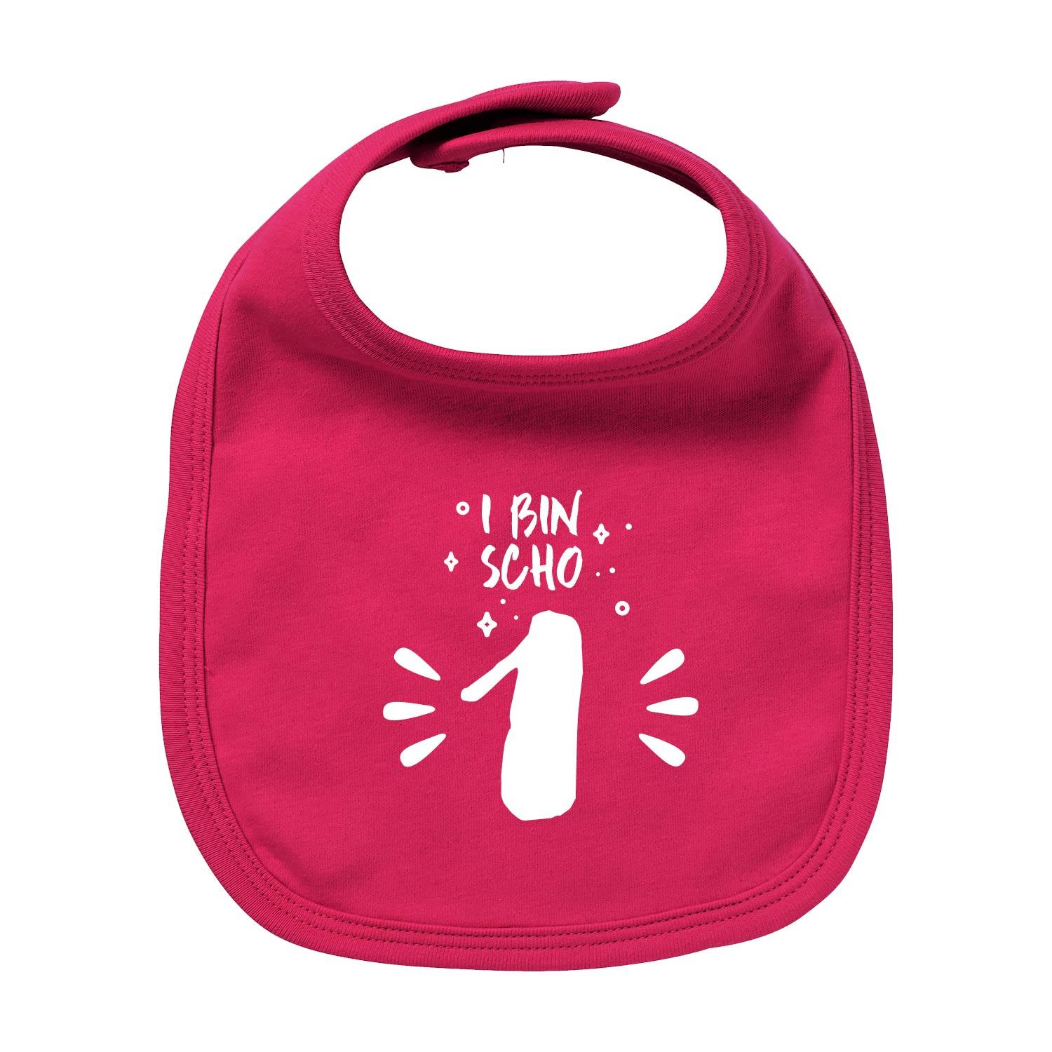 Weißes Baby-Lätzchen mit rotem Aufdruck „I bin scho 1!“, runde Form, aus Bio-Baumwolle, Siebdruck, 35 × 22 cm.