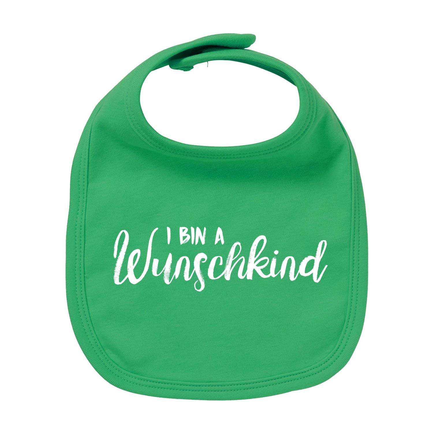 Weiβes Baby-Lätzchen mit blauem Herz-Motiv und rotem Schriftzug "Wunschkind", aus 100 % Bio-Baumwolle.