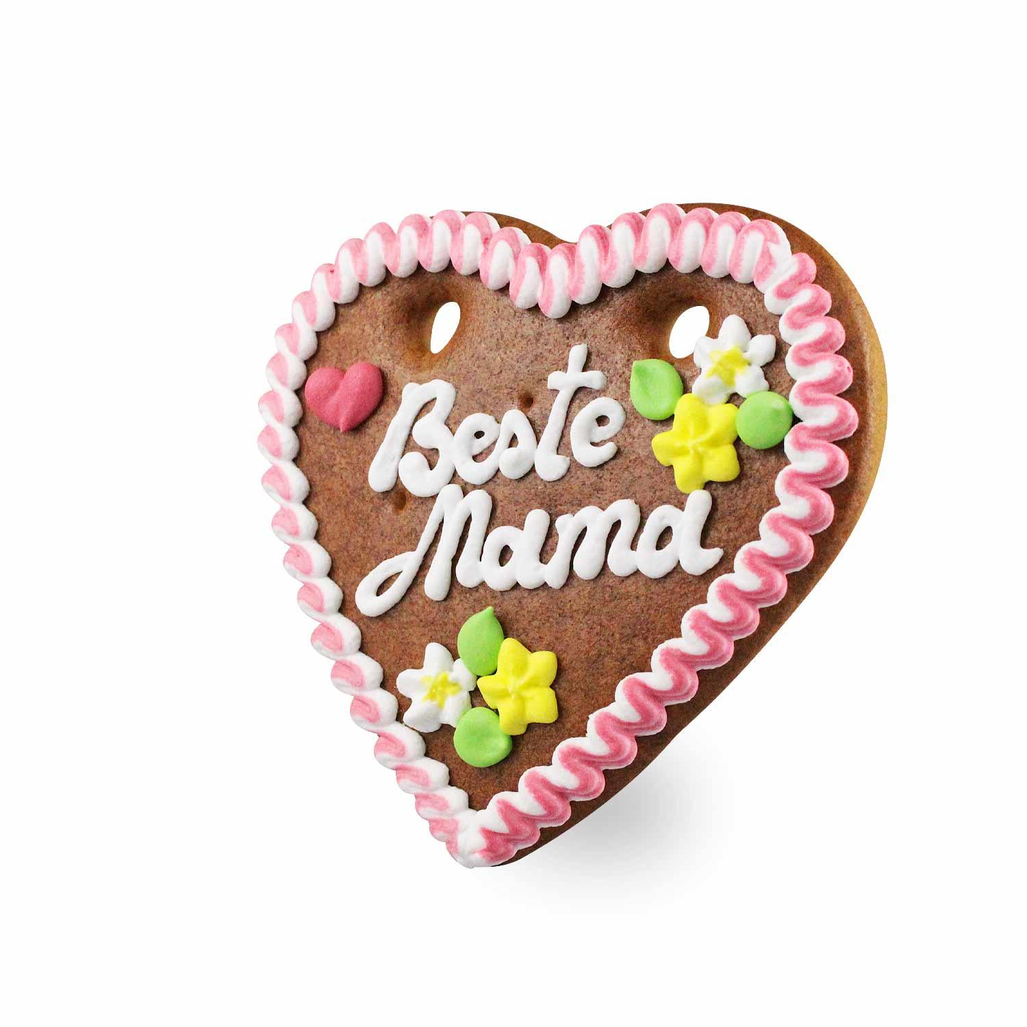 Herzförmiges Lebkuchenherz mit weiß-rotem Rand und rosa Schriftzug „Beste Mama“, verziert mit Blumen; ca. 14 x 17 cm, 100 g.