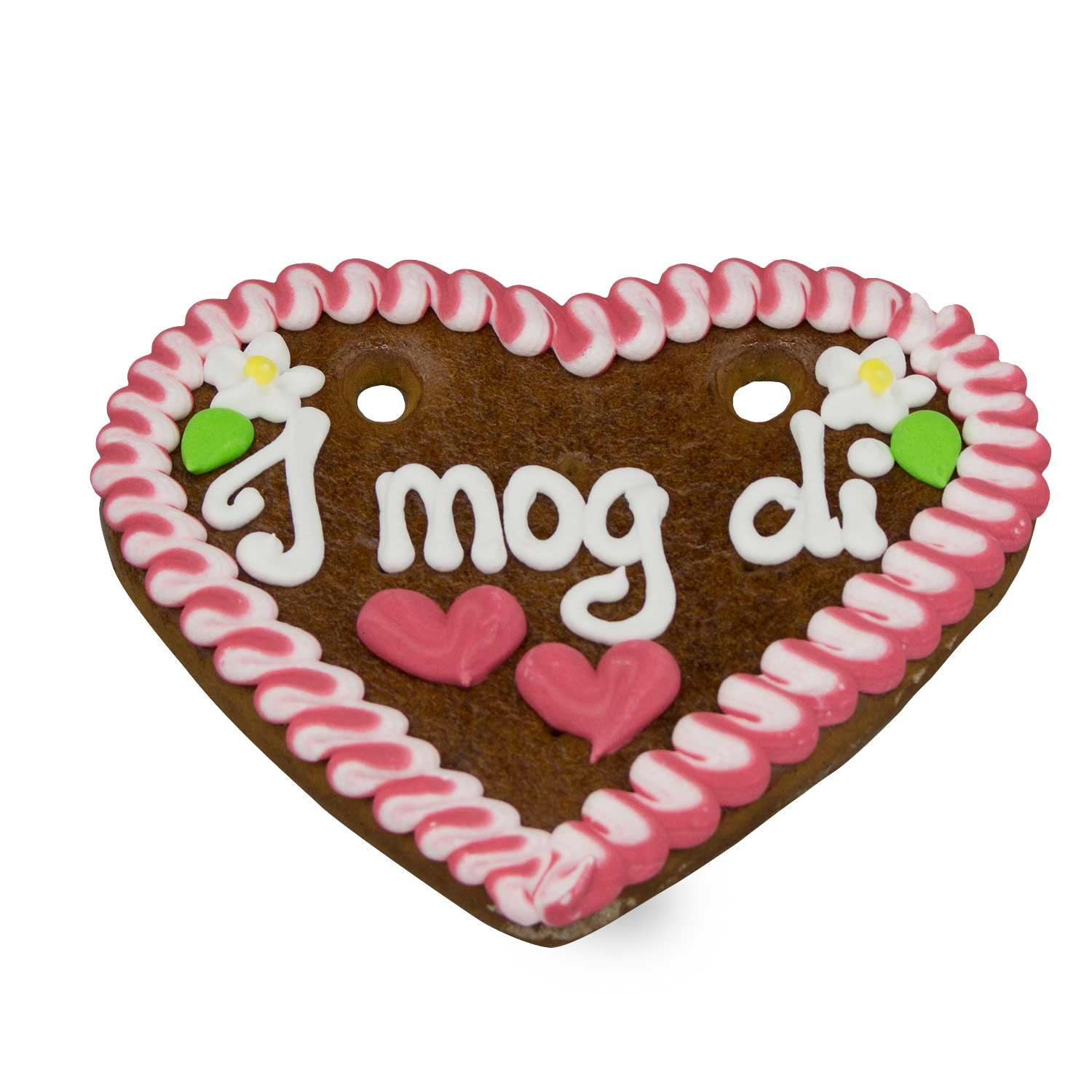 Herzförmiges Lebkuchen mit weißer, roter und blauer Zuckerdekoration und weißem Schriftzug „I mog di“, mit Umhängeband, ca. 14 x 17 cm.