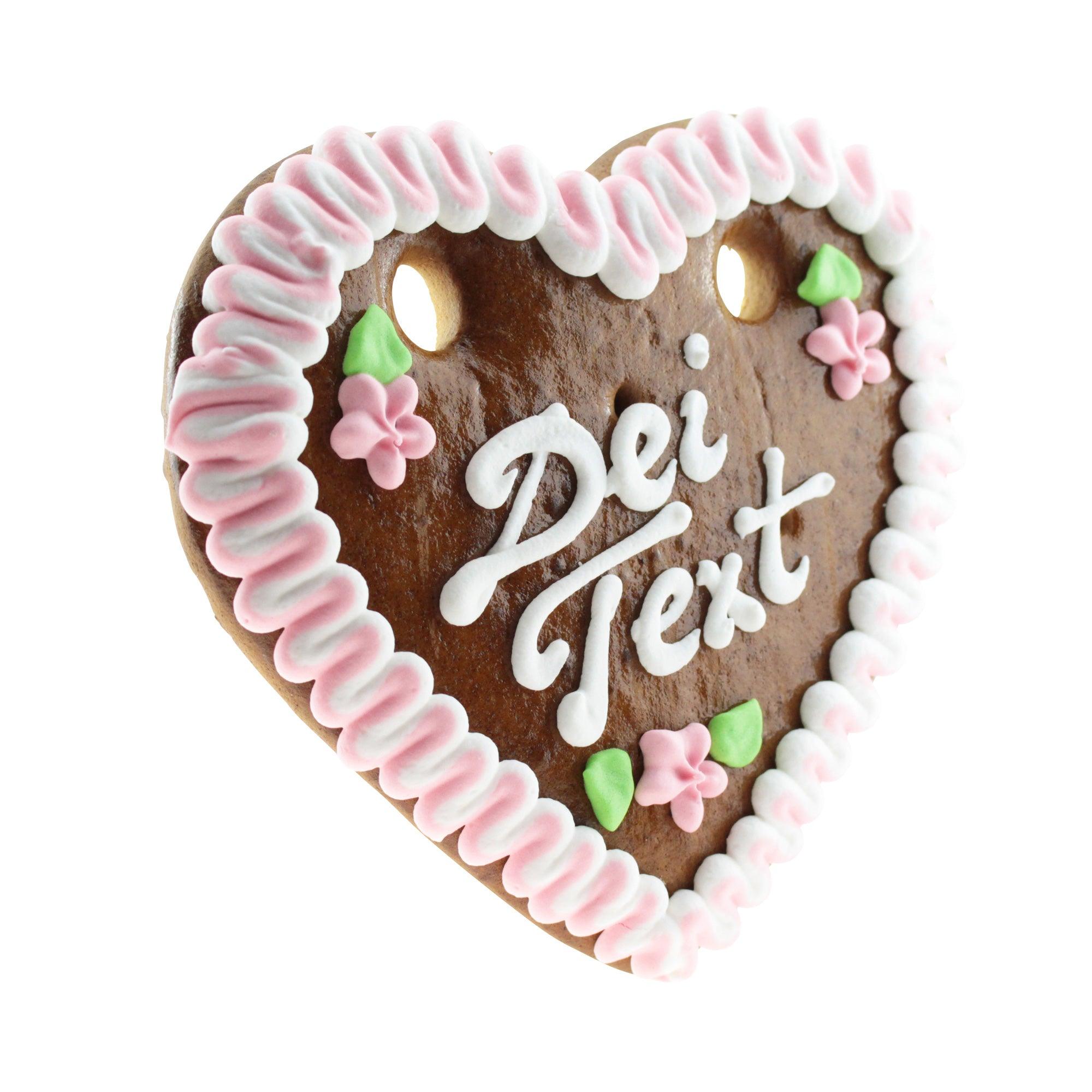 Herzförmiges Lebkuchenherz mit weißem Zuckerrand, blauem Schleifenmotiv und personalisierbarem Schriftzug; ca. 14 x 17 cm, 100 g.