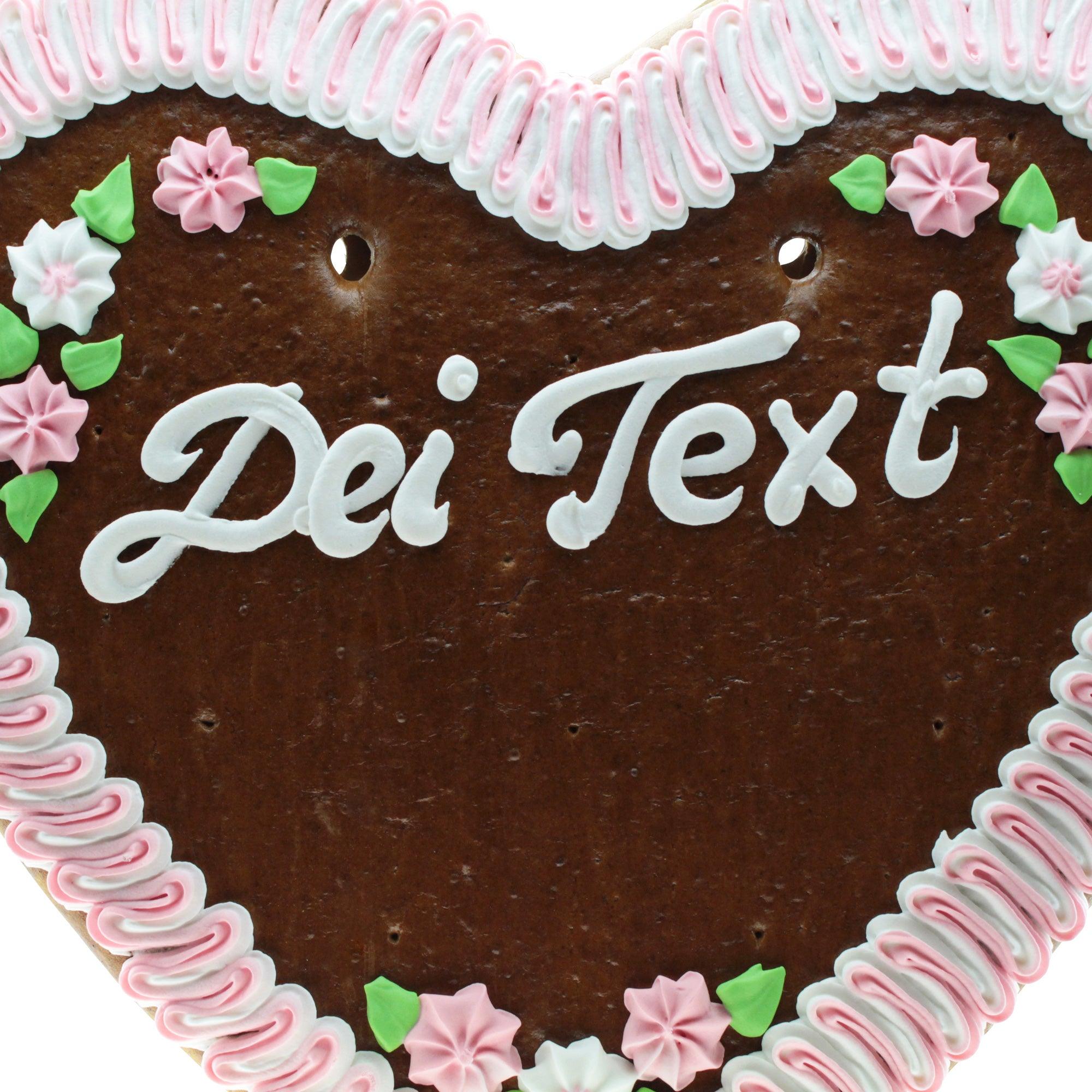 Großes Lebkuchenherz mit Zuckerguss-Verzierungen, rot-weißem Rand und individuell wählbarem Schriftzug in Weiß; ca. 50 x 48 cm, 1 kg.