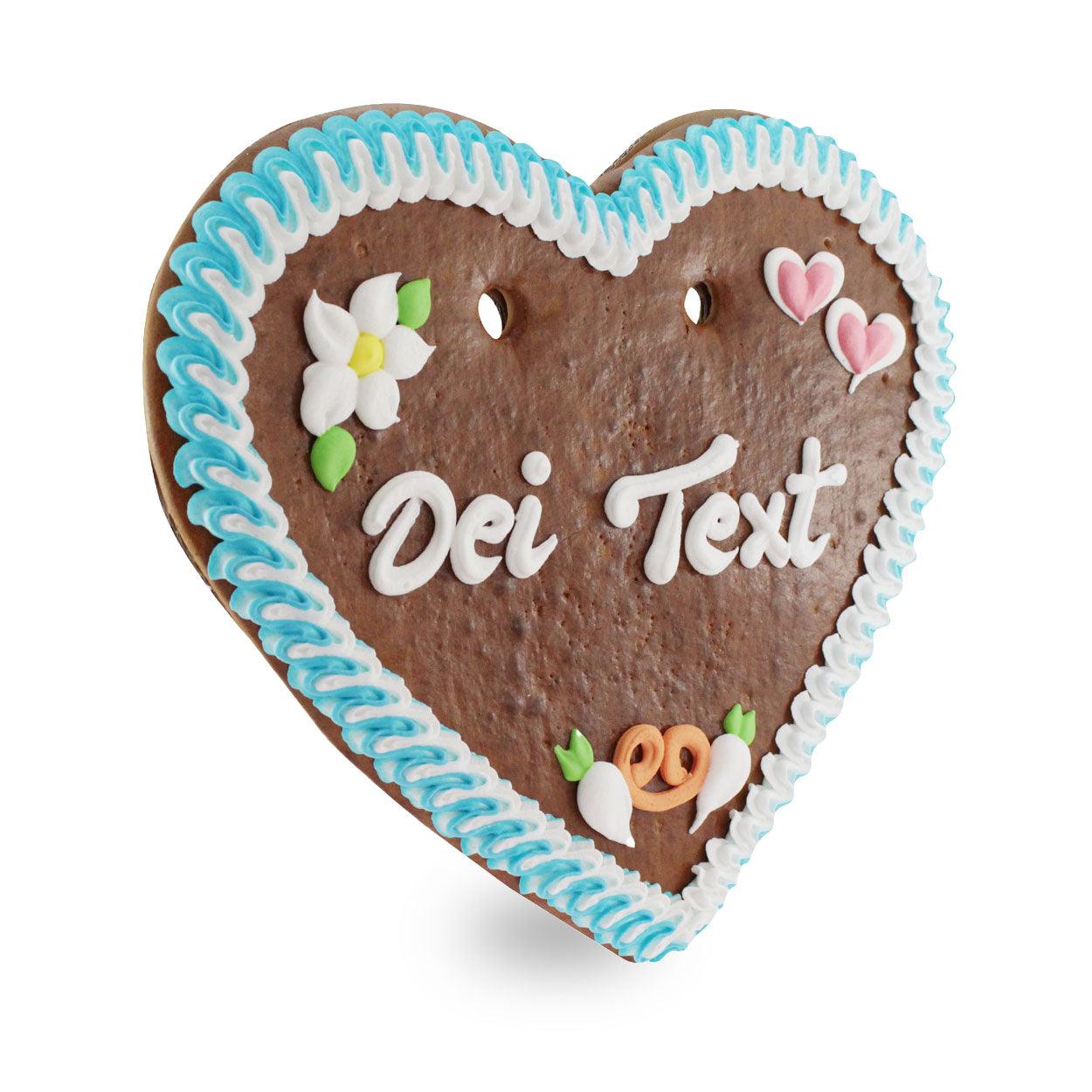 Herzförmiges Lebkuchenherz mit rot-weißem Zuckerrand, weißem Schriftzug und Blumen aus farbigem Zuckerguss; ca. 36 x 34 cm, 500 g.
