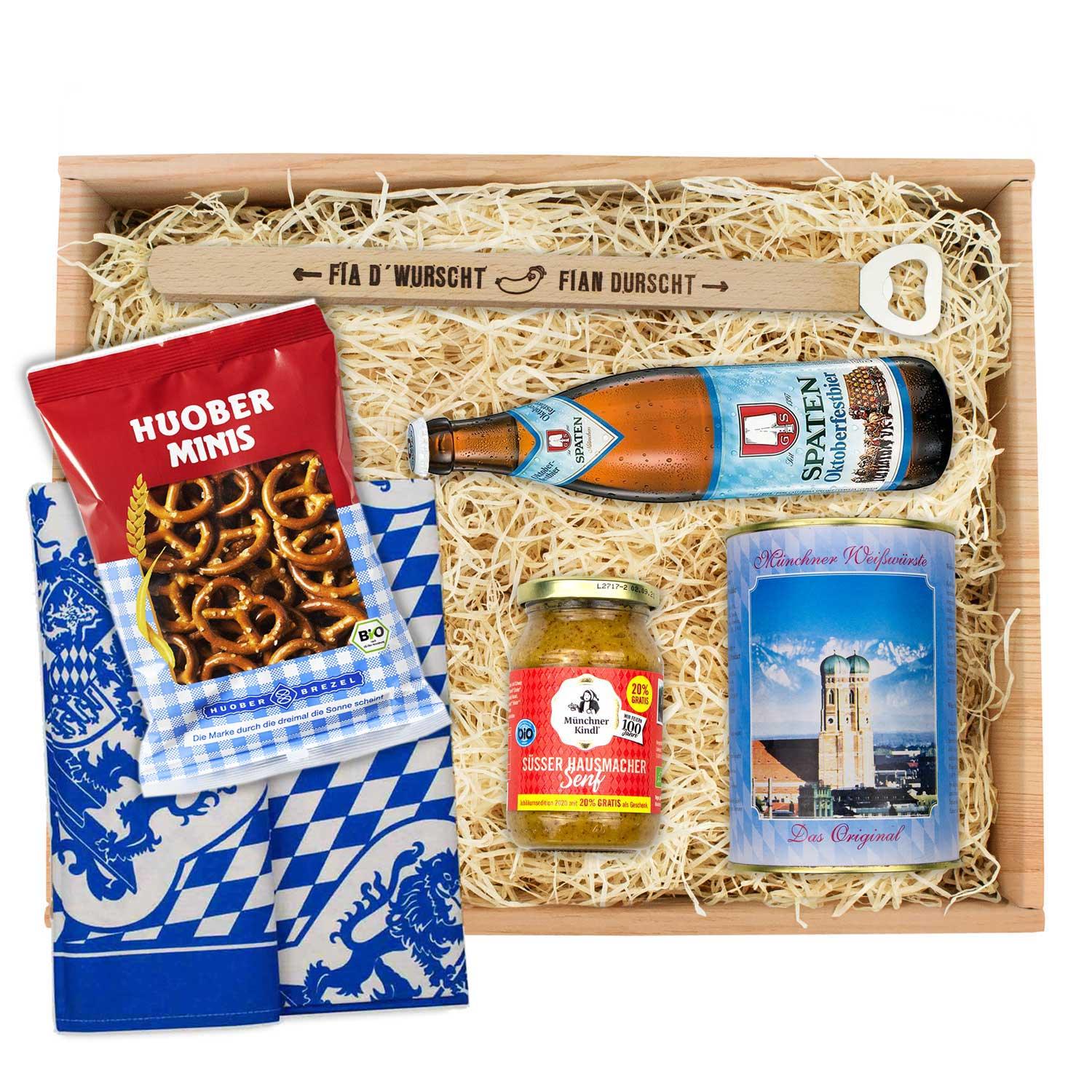 Oktoberfest-Box mit vier Weißwürsten, süßem Senf, Brezn und wählbarem Oktoberfestbier in Glasflasche.