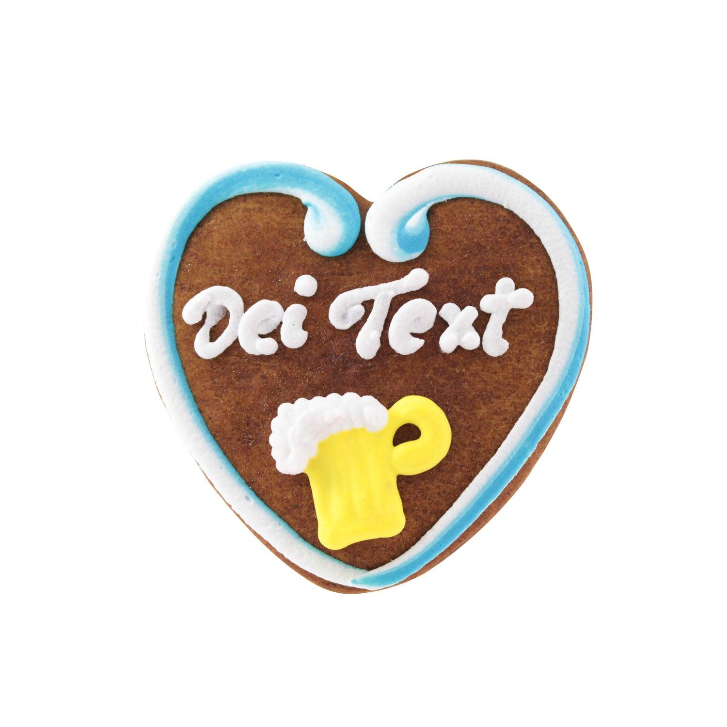 Herzförmiges Lebkuchenherz mit rosafarbenem Zuckerrand, blau-weißen Blumen und weißem Wunschtext aus Zuckerschrift, ca. 10 cm groß.