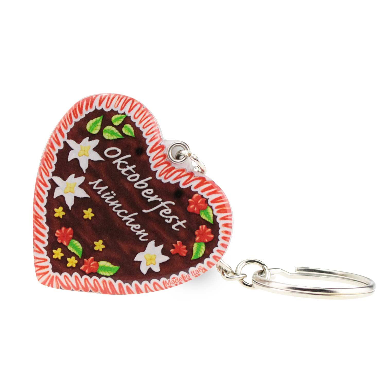 Herzförmiger Schlüsselanhänger in Lebkuchenoptik mit bunter Zuckerschrift und Text „Oktoberfest München“, ca. 5 × 4 cm.
