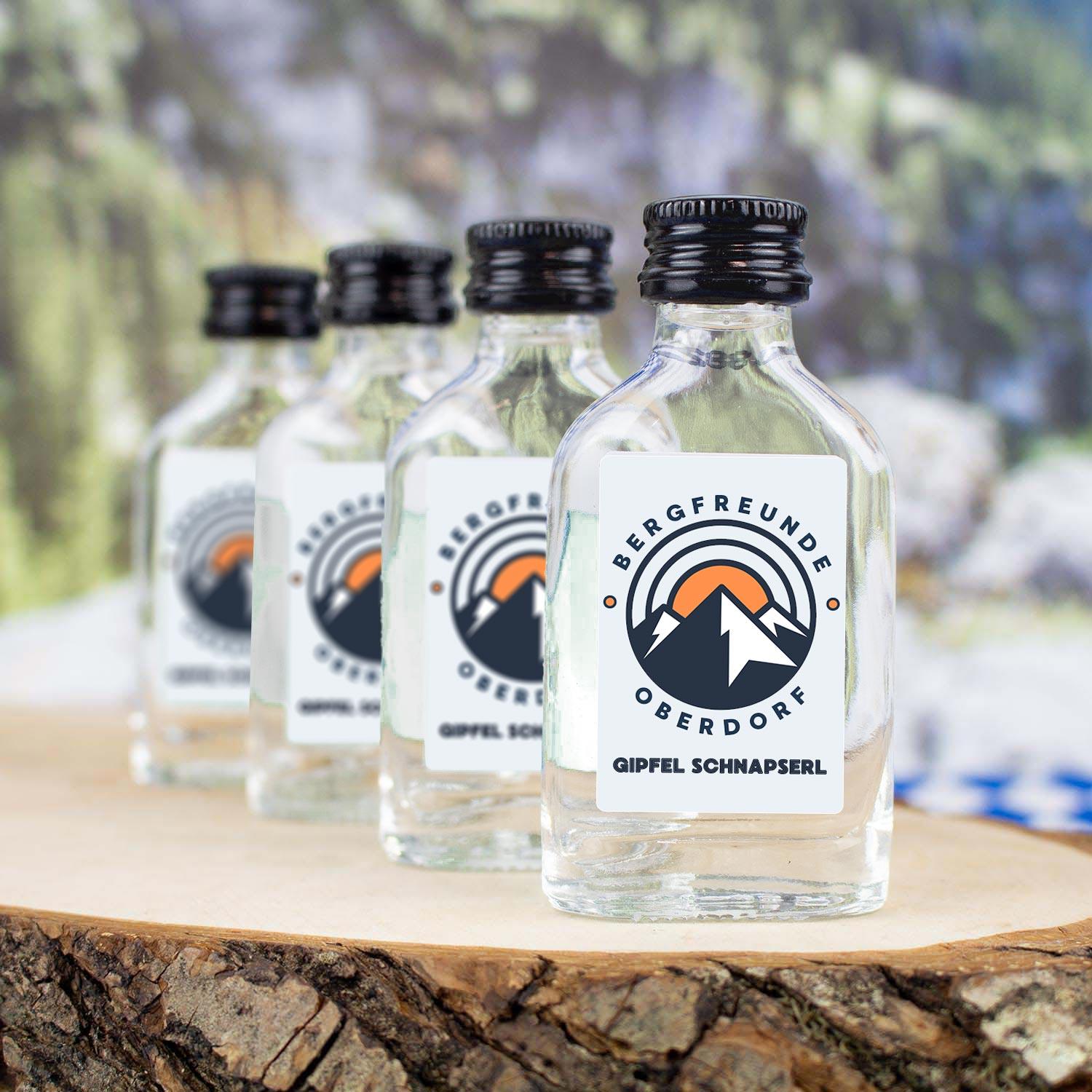 Clear-Glasfläschchen mit transparentem Obstbrand, weißem Schraubverschluss und individuellem Logo-Aufdruck, 2 cl, 144 Stück.