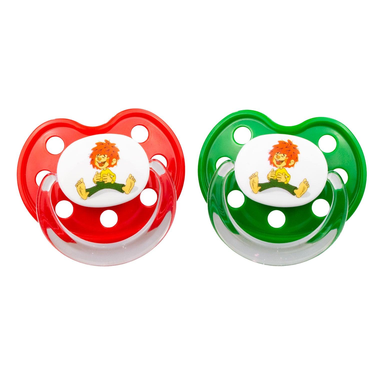 Zwei Pumuckl Schnuller Dizzl mit rotem und grünem Schild, jeweils mit einer Abbildung des Kobolds.