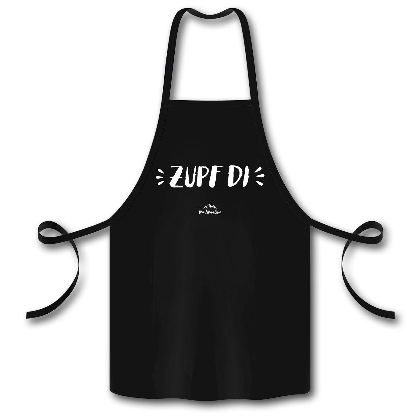 Kochschürze mit zentralem „Zupf di!“-Schriftzug, Halsschlaufe, Bindebändern und glatter Struktur aus Bio-Baumwolle.