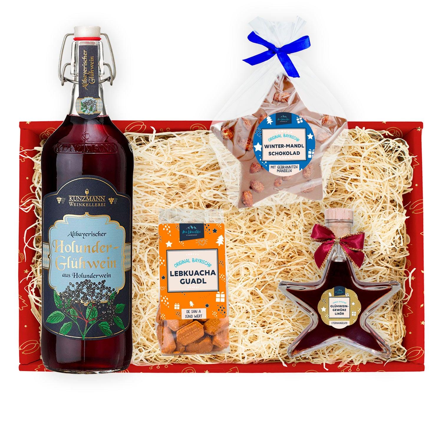 Geschenkbox mit Glühweingewürz-Likör, Holunder-Glühwein und Packung Lebkuchenbonbons, je in stilvoller Glasflasche.