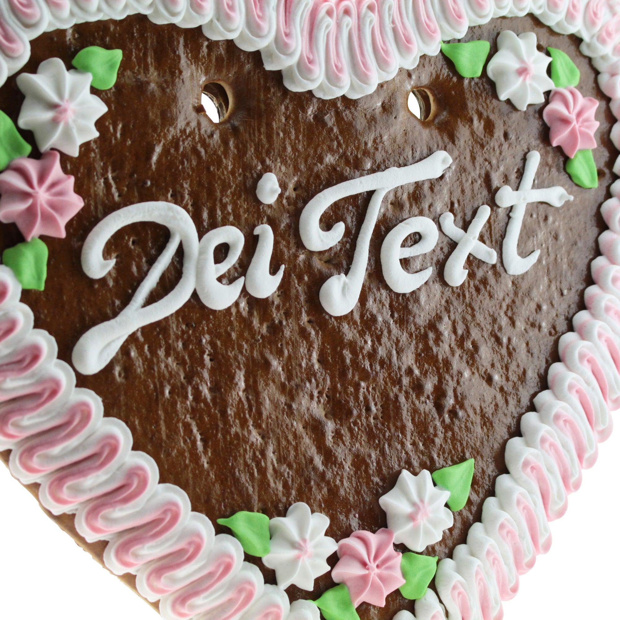 Herzförmiges Lebkuchenherz mit bunter Zuckerschrift und Blumendekor, handgefertigt aus braunem Lebkuchenteig, ca. 36×34 cm.