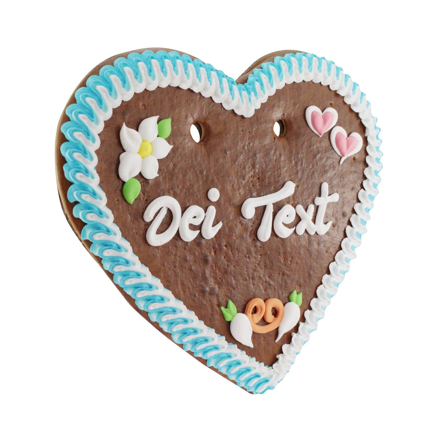 Herzförmiges Lebkuchenherz mit weiß-blauem Rand, rosafarbenen Rosetten und weißer Zuckerschrift auf braunem Teig, ca. 36 x 34 cm.