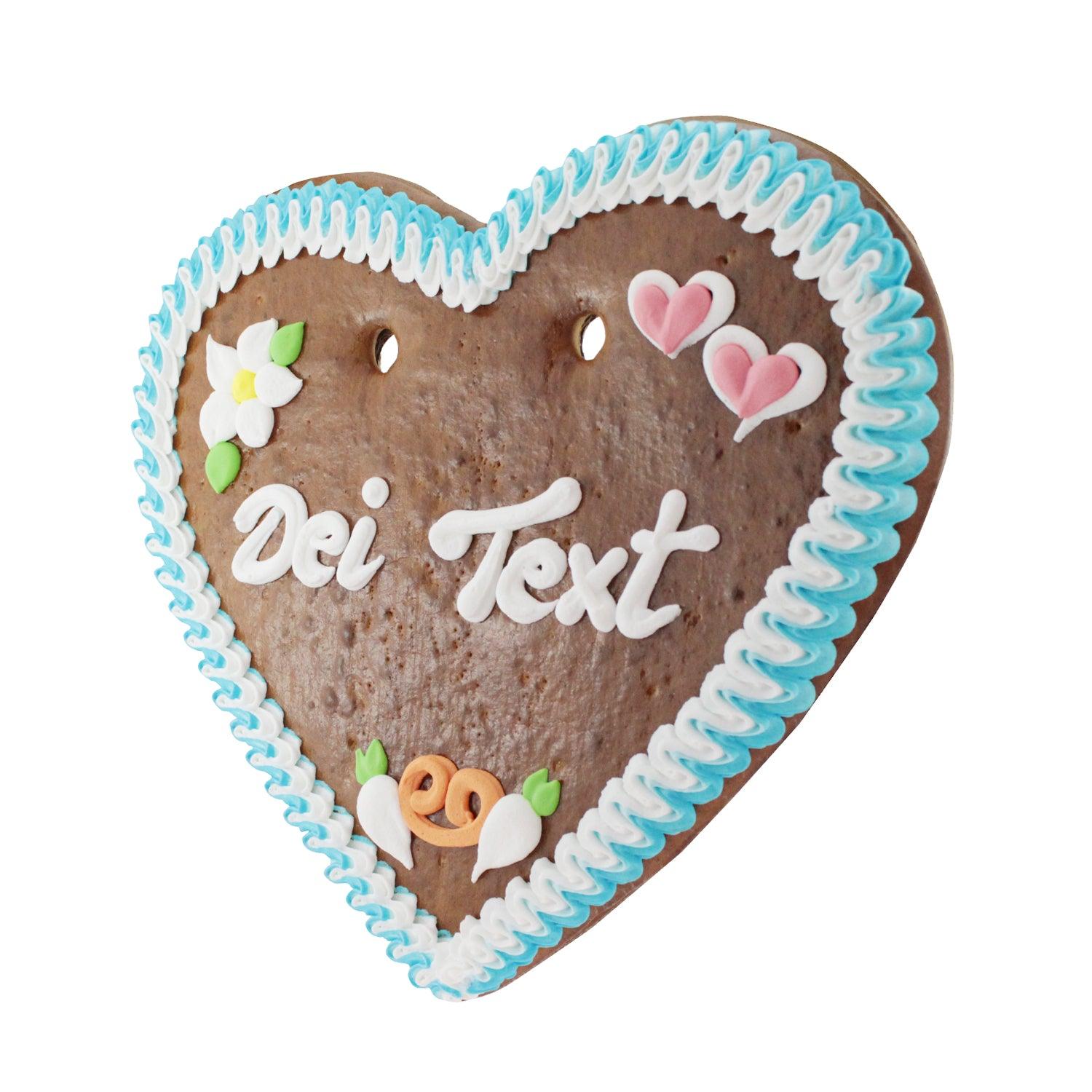 Braunes Lebkuchenherz mit weißer Zuckerglasur, rotem Rand, rosa Rosen, blauem Herzmotiv und handgeschriebener Beschriftung; ca. 36 x 34 cm, 500 g.