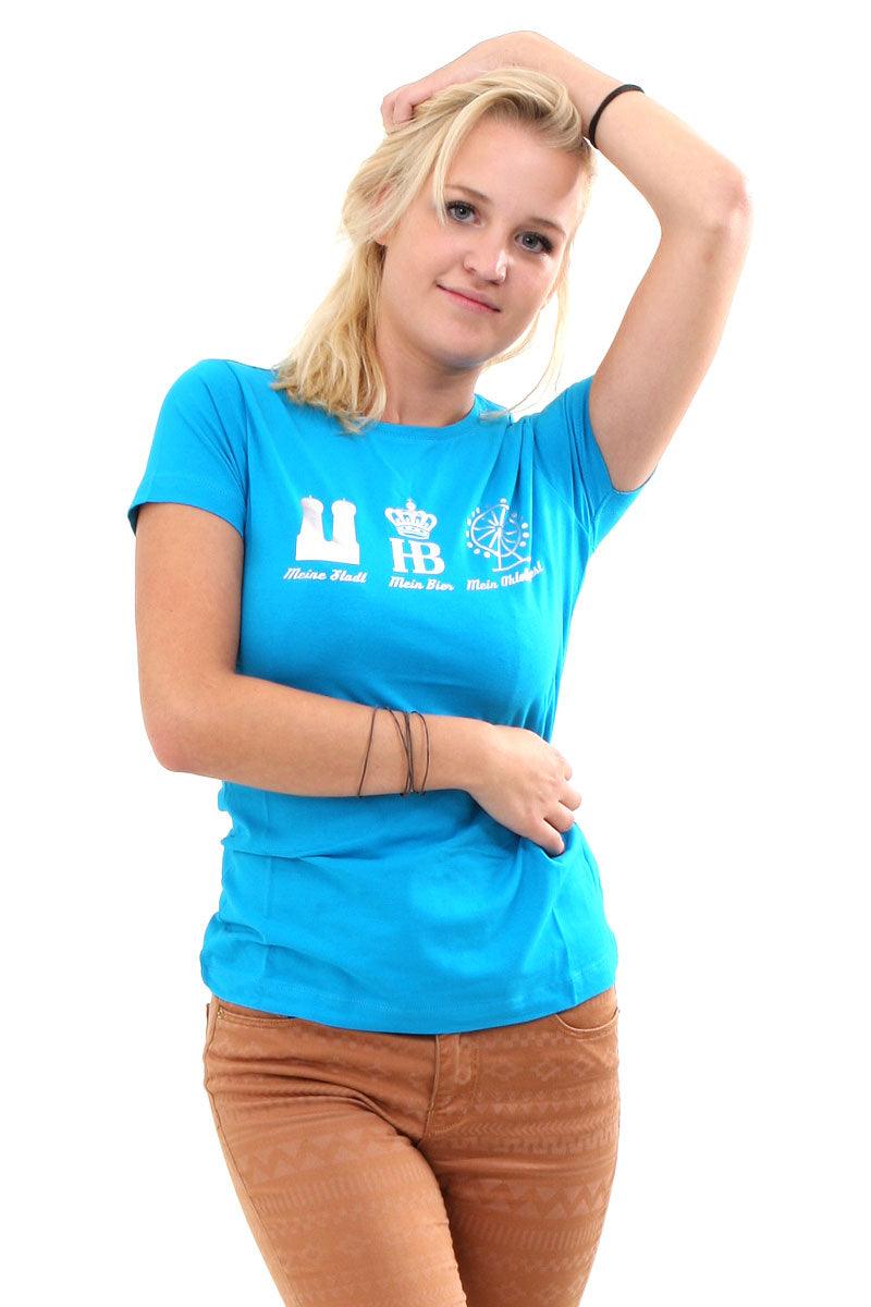 Tailliertes Damenshirt in Türkis mit silbernem „Mein Oktoberfest“-Schriftzug aus glänzender Folie, 95 % Baumwolle.