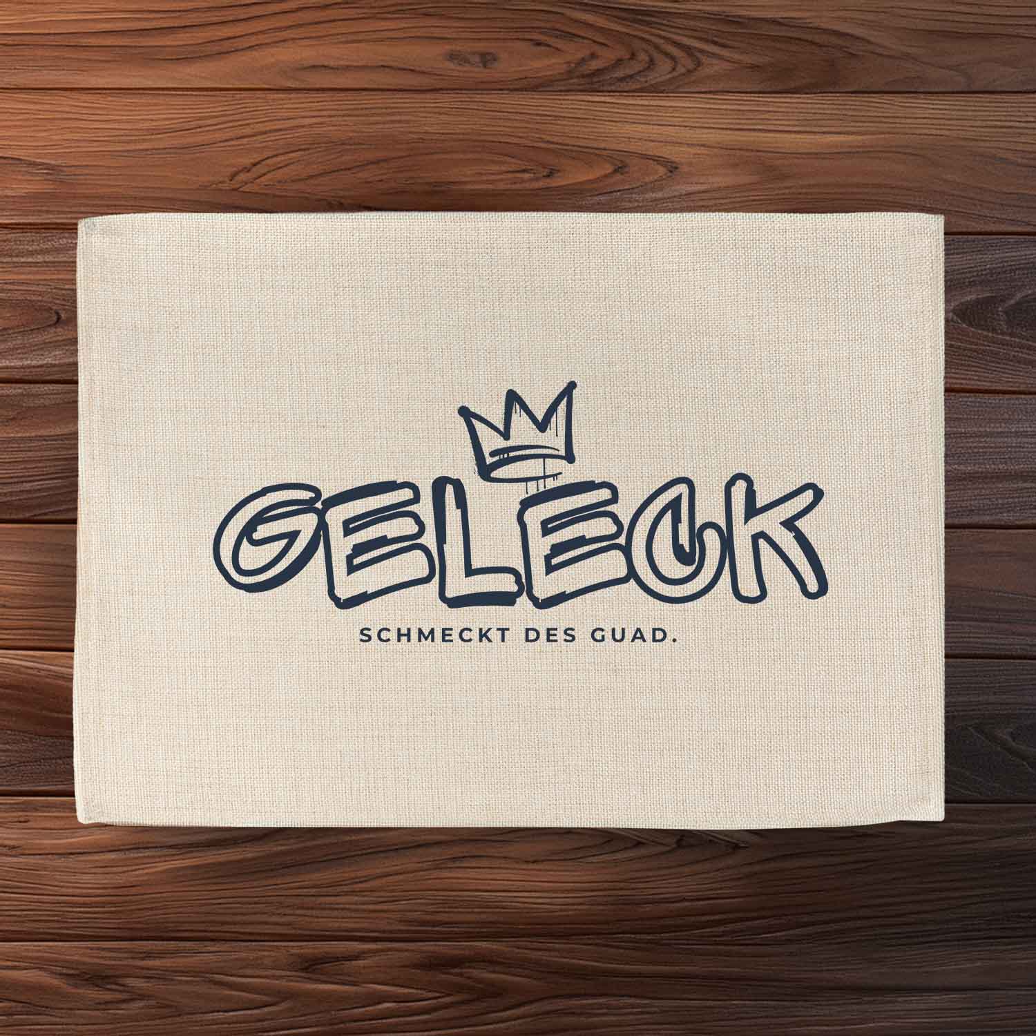 Abwaschbares Tischset in Jute-Optik mit bayerischem Spruch „Geleck“ und hochwertigem Druck, rechteckig, 40,5×30,5 cm.