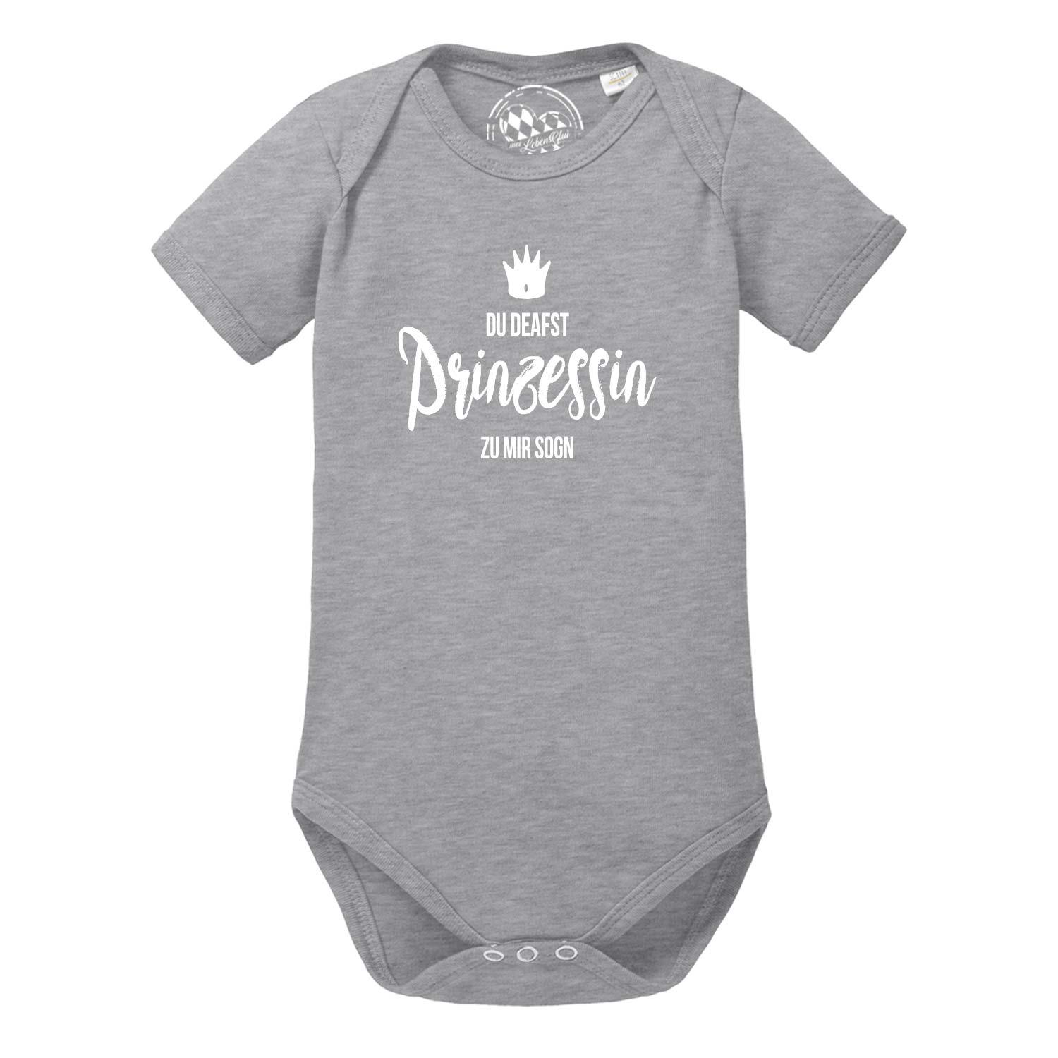 Weißer Babybody mit rosa Schriftzug „Prinzessin“, Herzmotiv und kleinen Kronen; Kurzarm; aus Baumwolle.