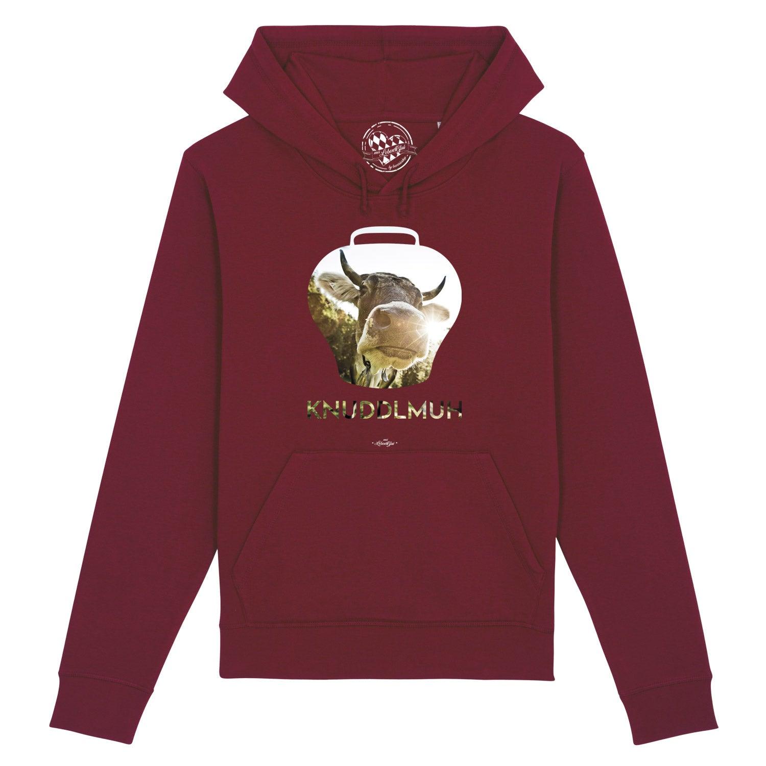 Damen-Hoodie in Hellgrau mit schwarzem Kuh-Motiv und bayerischem Schriftzug „Knuddlmuh“, aus Bio-Baumwolle.