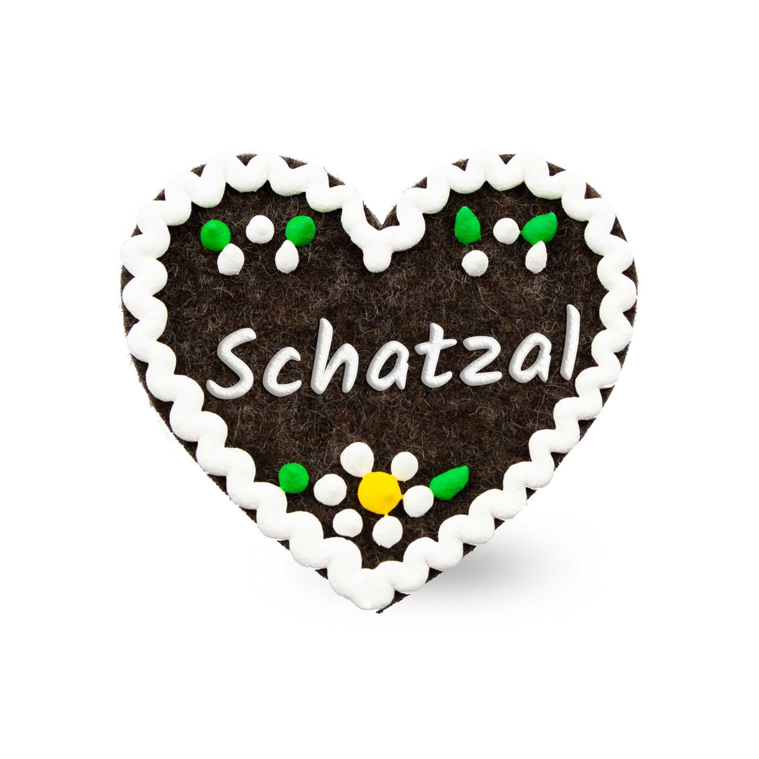 Filzherz-Anstecker in Herzform mit aufgenähtem Schriftzug „Schatzal“, Rückseite mit Sicherheitsverschluss, ca. 6,5 x 7 cm.