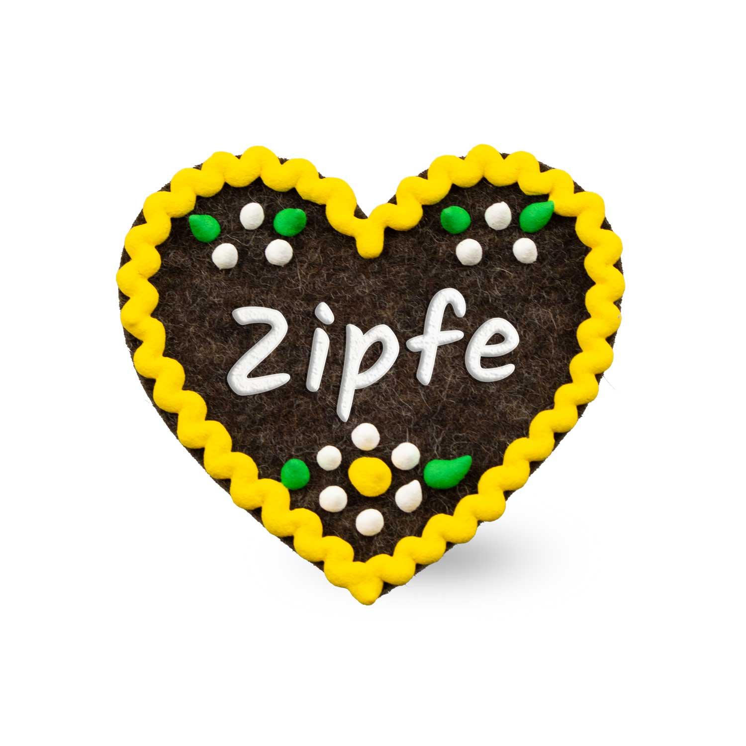Herzförmiger Filz-Anstecker mit aufgesticktem Schriftzug „Zipfe“ und Sicherheitsverschluss auf der Rückseite, ca. 6,5 x 7 cm.
