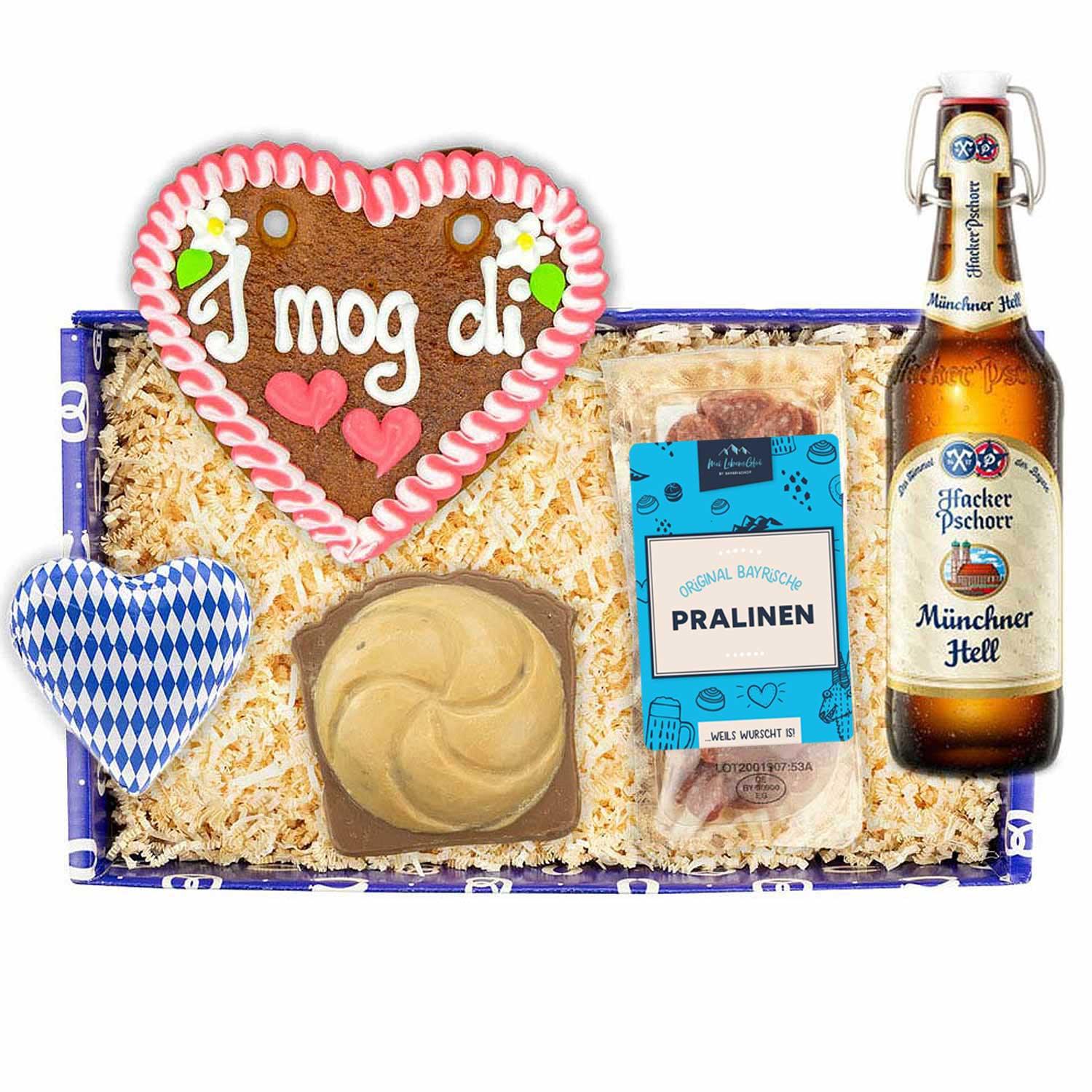 Bayerische Geschenkbox mit Tegernseer Bierflasche, Schoko-Leberkässemmel und Lebkuchenherz mit „I mog di“-Schriftzug.