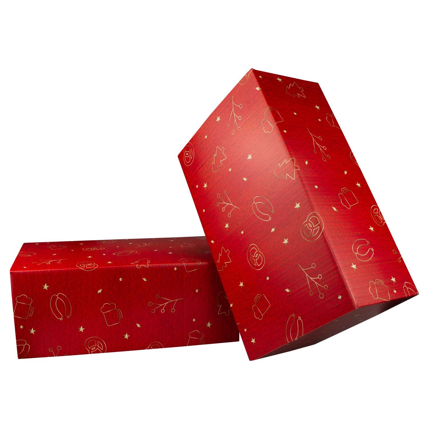 Zwei rote Weihnachtsboxen Koids Glüh-Bier, mit goldenen Symbolen von Christbäumen, Brezeln und Bierkrügen.