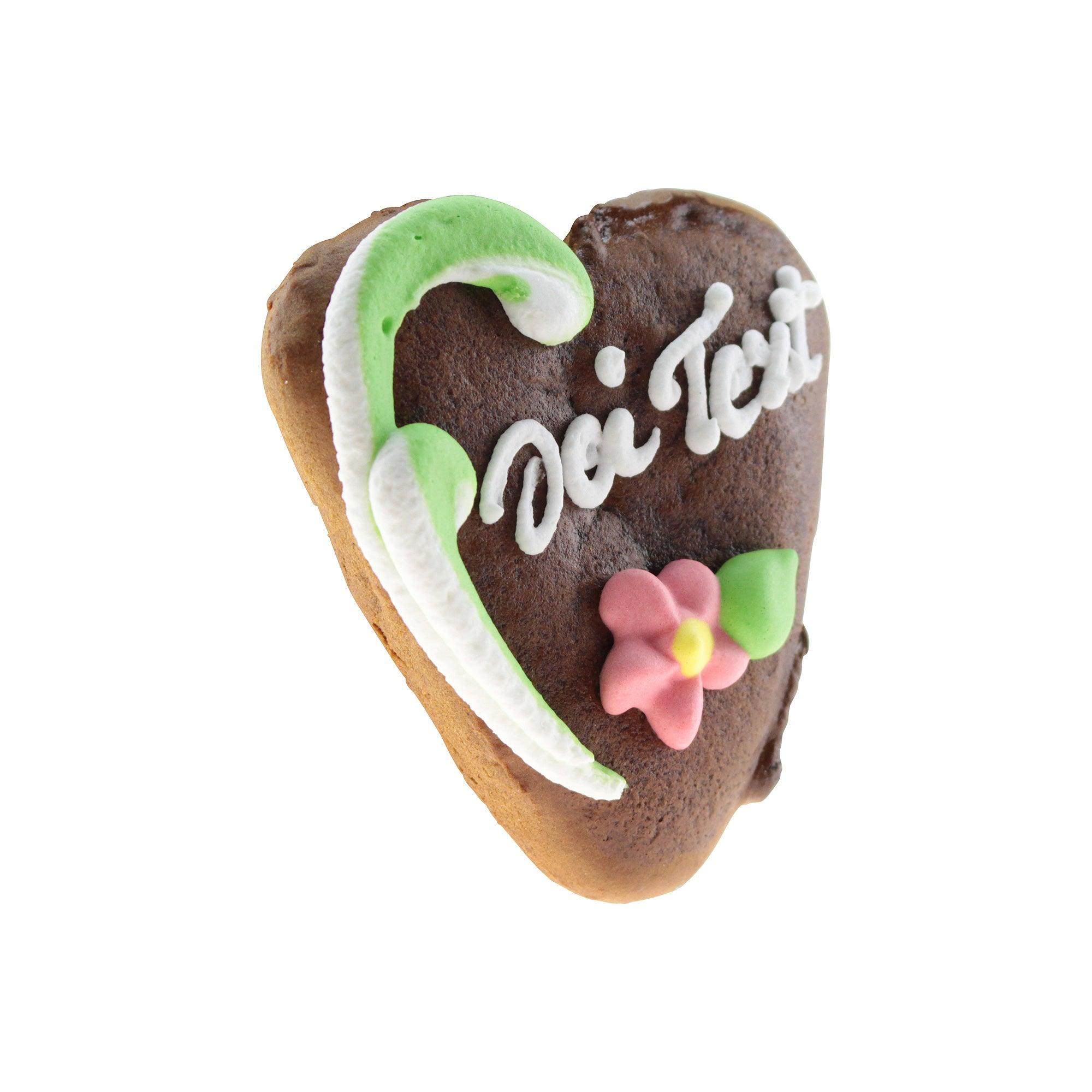 Braunes Mini-Lebkuchenherz mit weiß-rotem Zuckergussrand und individuellem Wunschtext auf rosa Zuckerschrift, ca. 7 x 8 cm.