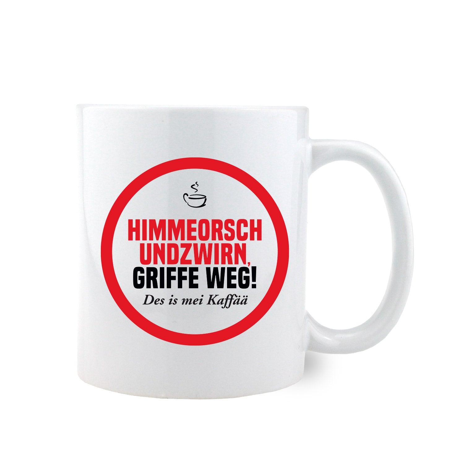 Weiße Keramiktasse mit schwarzem Henkel, Aufdruck „Himmeorschundzwirn, GRIFFE WEG...“, zylindrische Form, ca. 330 ml.