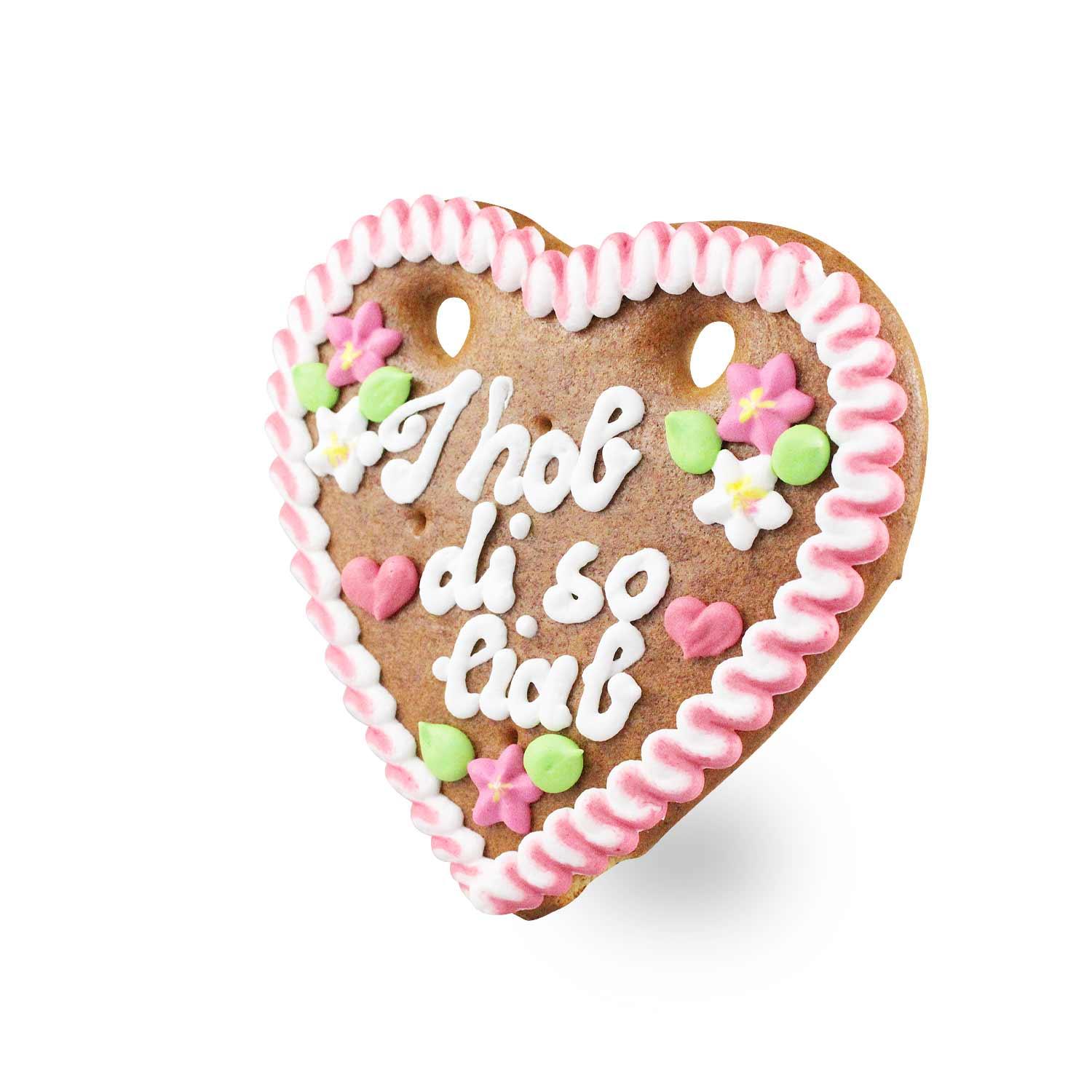 Herzförmiges Lebkuchenherz mit weißem Rand, Spruch „I hob di so liab“, verziert mit roten und blauen Zuckerrosen, ca. 14 × 17 cm.