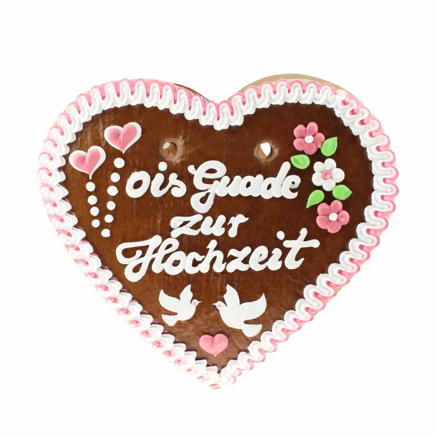Herzförmiges Lebkuchenherz mit weißer und rosa Zuckerschrift „Ois Guade zur Hochzeit“, braun, mit rosa Rand, ca. 36 x 34 cm.