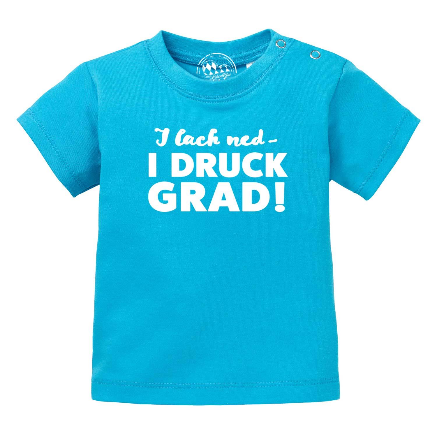 Türkises Baby T-Shirt "I lach ned - I DRUCK GRAD!" mit Druckknöpfen an der Schulter für einfaches Anziehen.